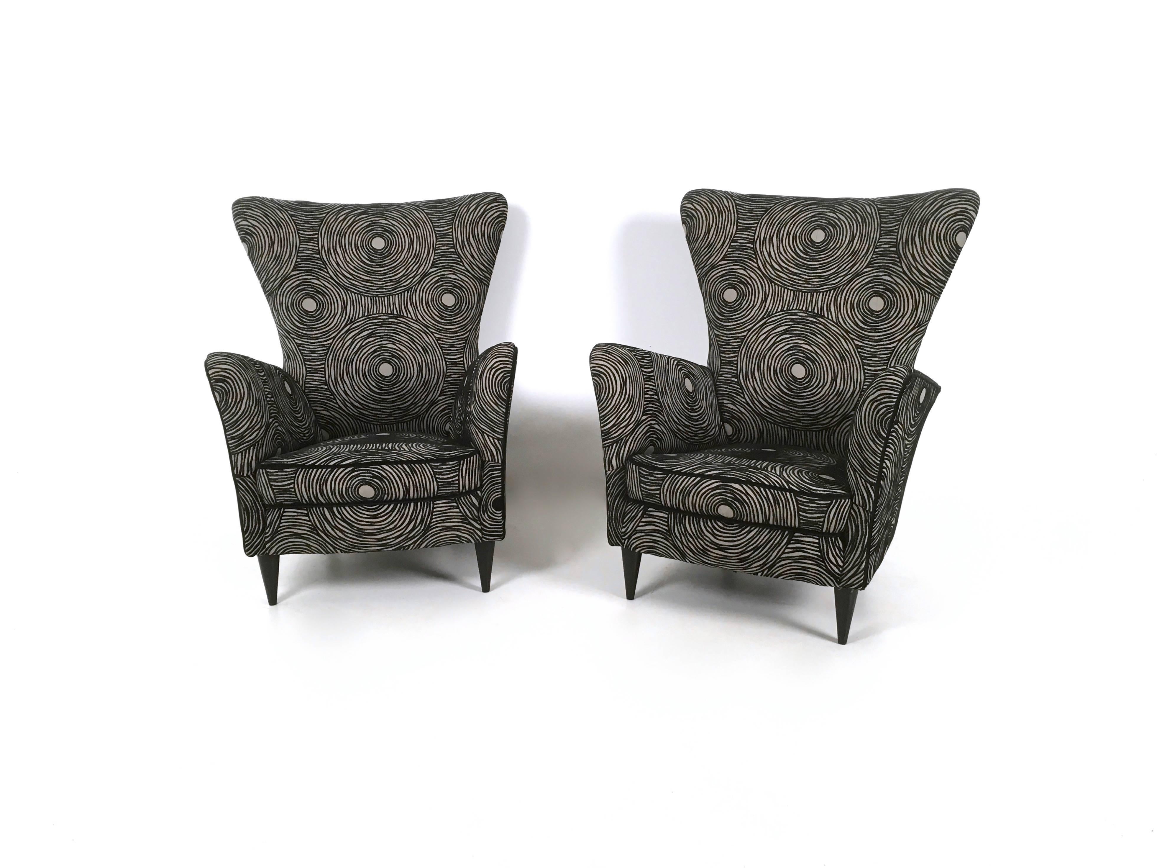 These armchairs are ascribable to Gio Ponti for Hotel Bristol Merano.
They are upholstered in fabric with a black a white pattern and feature ebonized wood feet.
The upholstery is new.
They may show slight traces of use since they're vintage, but