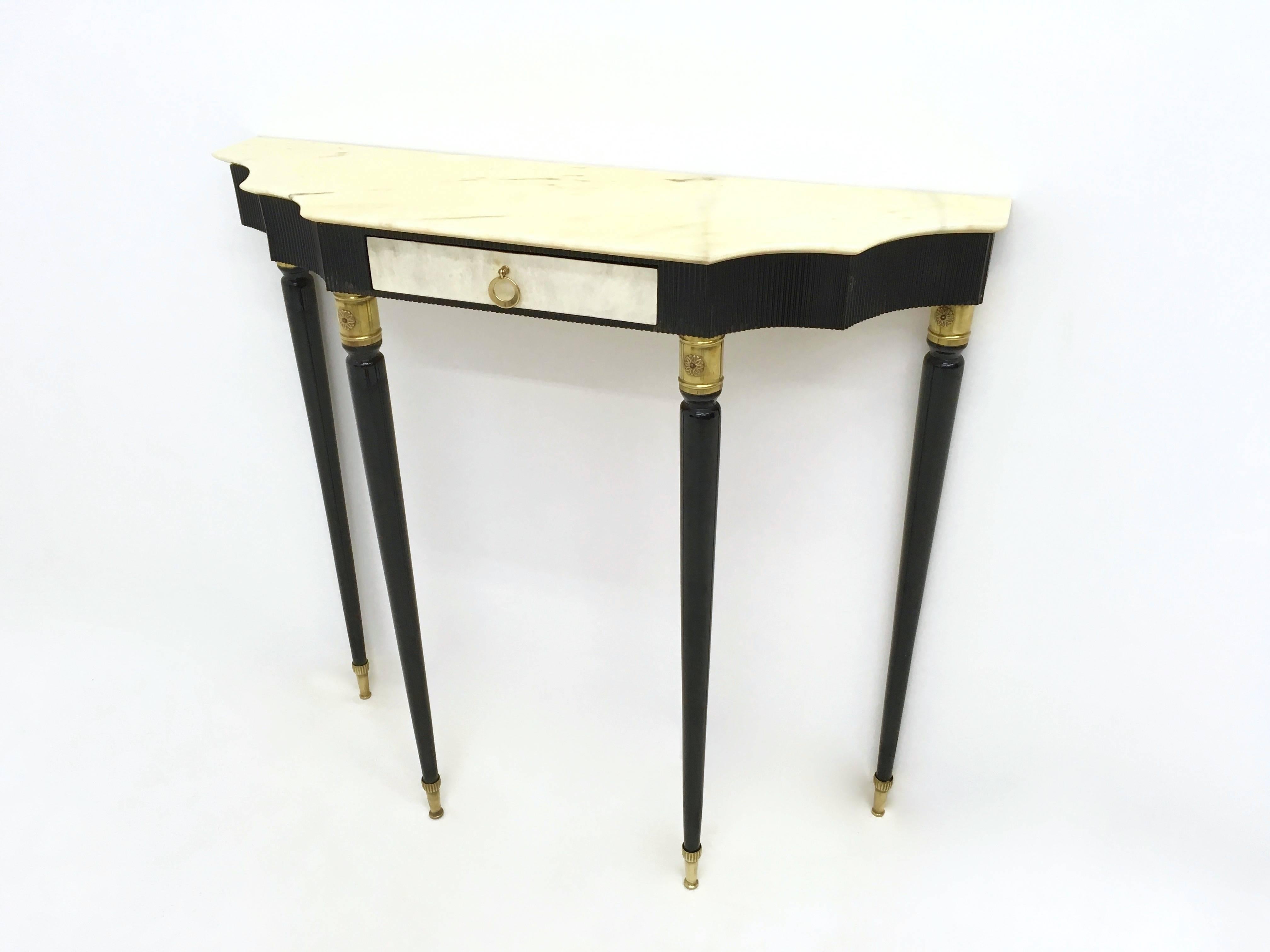 Made from ebonized wood, Carrara marble and brass elements. The drawer is parchment veneered.
It has been restored.
It is in perfect condition and it is ready to become a piece in the home.