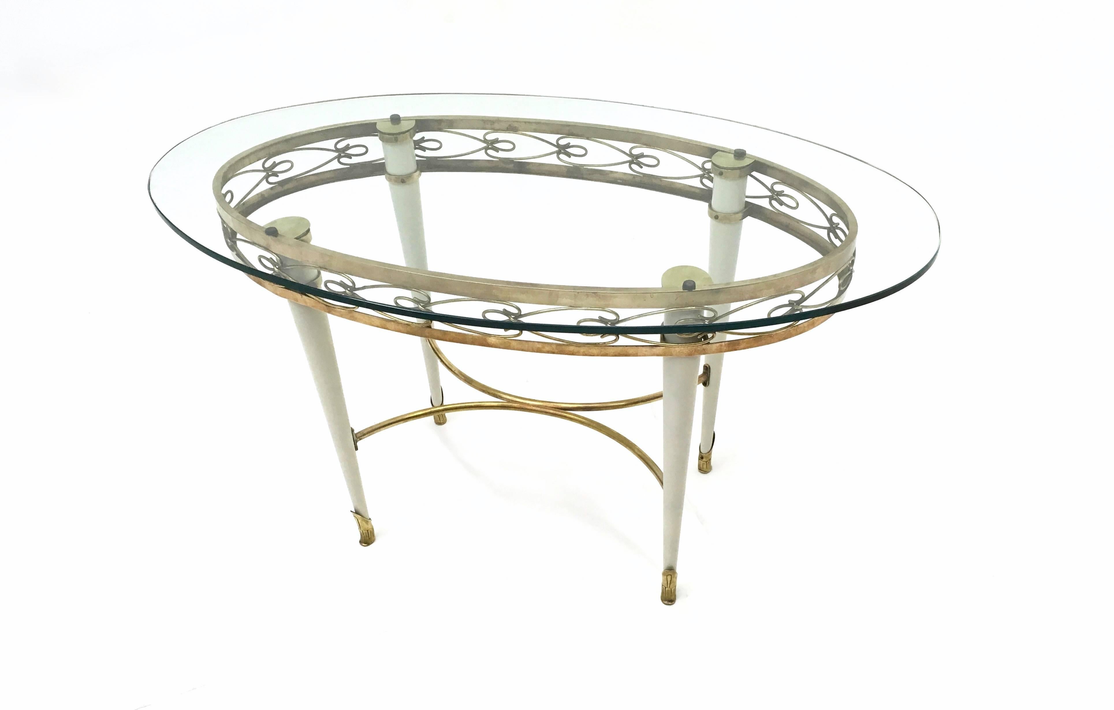Mid-Century Modern Brass Coffee Table with an Oval Glass Top in the Style of Pierluigi Colli, Italy For Sale