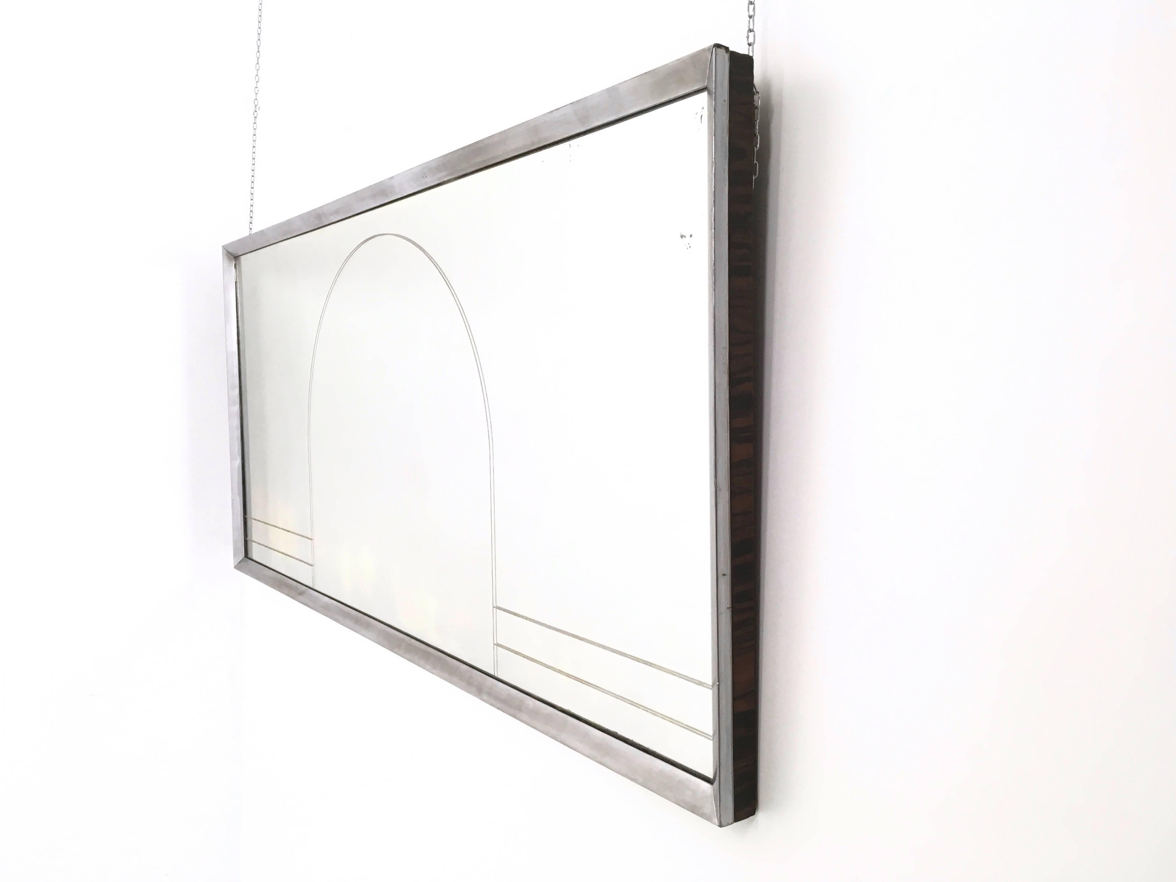 Made from nickel-plated metal, engraved mirror and Macassar ebony veneered frames.
 