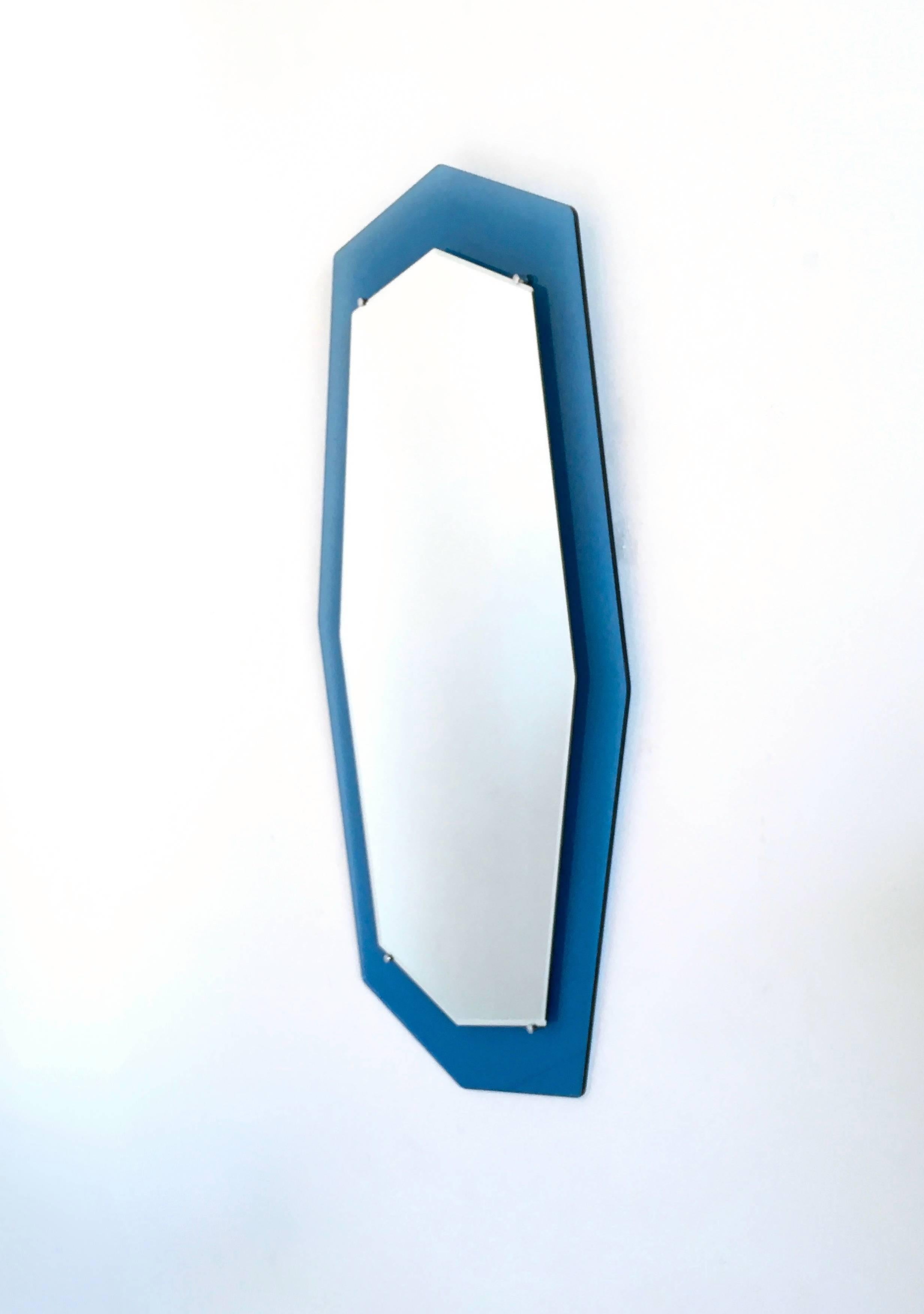 It is made from blue glass and mirror and has chromed metal parts. 
Produced by Italo900.
It is a unique piece so this gives it the fascination of distinctiveness.
 