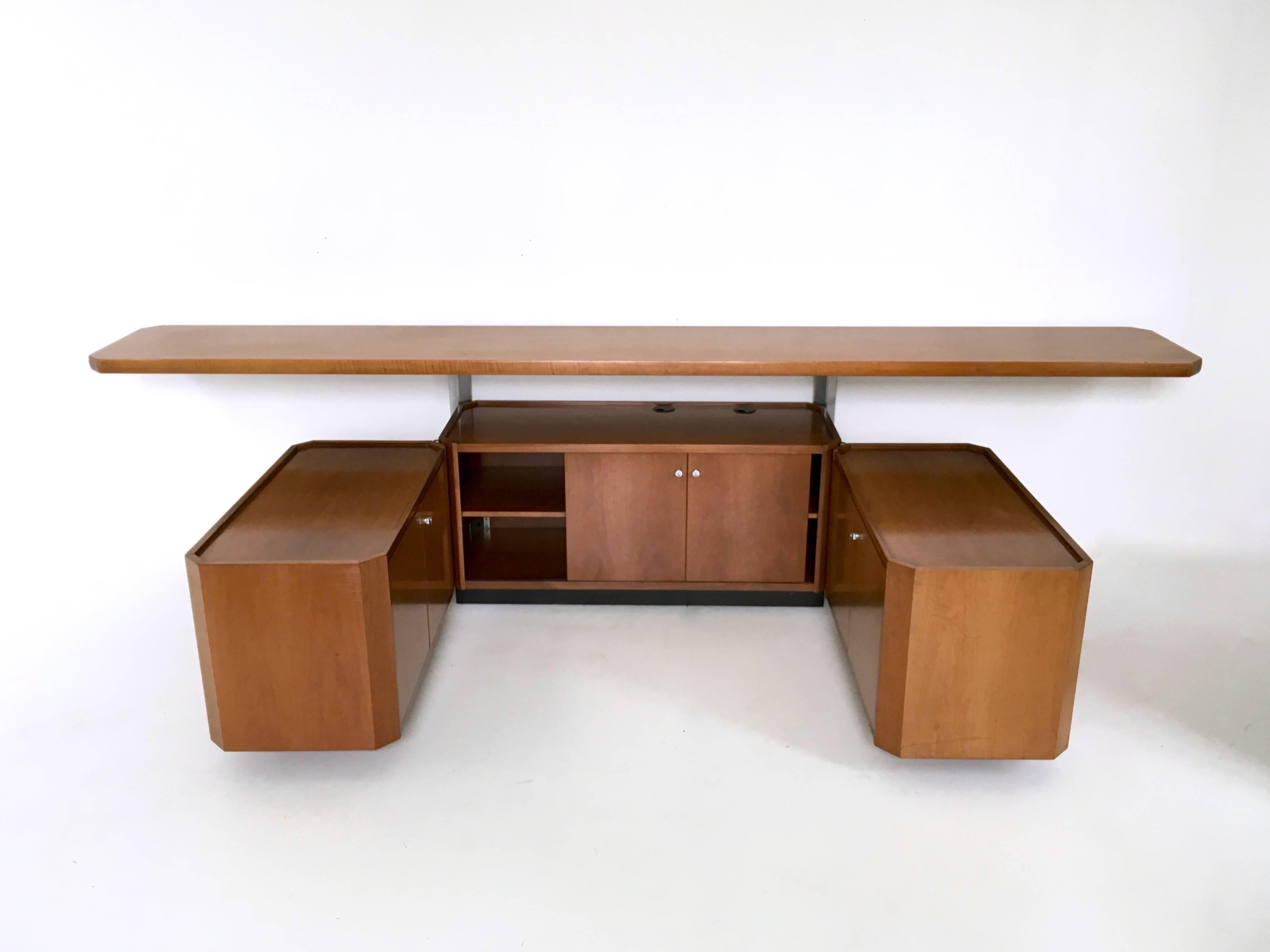 Made from walnut, with chromed metal parts.
The previous owner used it as a Tv stand so it has holes for wires.
It is labelled TECNO.
In perfect condition.