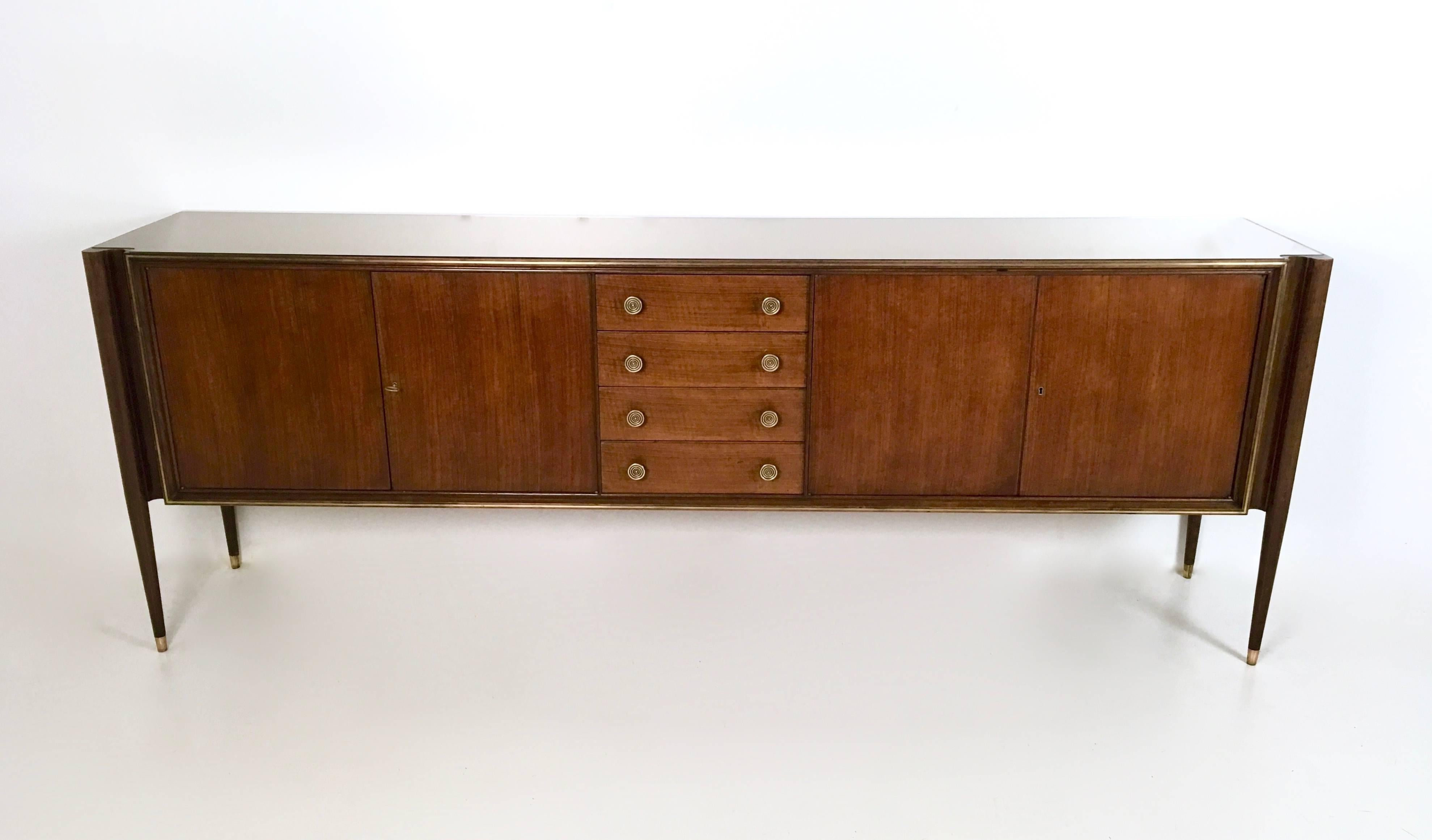 It has a mirrored top.
Made from walnut and brass.
There is a similar model which is by Borsani. 
It is in excellent condition. 

             