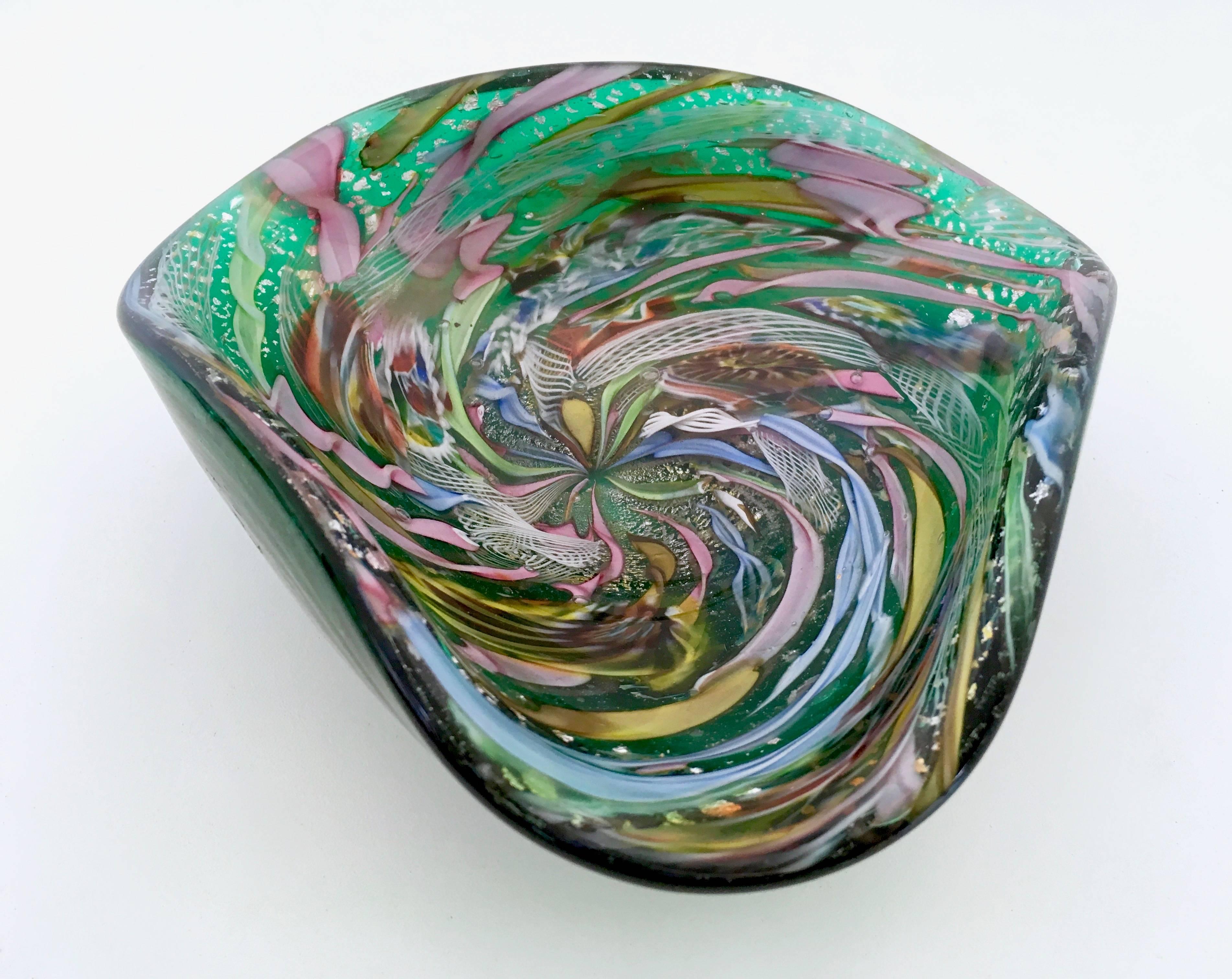 Murano, 1950s. 
Multicolored handblown glass ashtray designed by Dino Martens for Aureliano Toso. 
It has particles of coal, included in the glass, due to its process of manufacturing: this is because in 1950s, in Murano, wood-burning ovens were