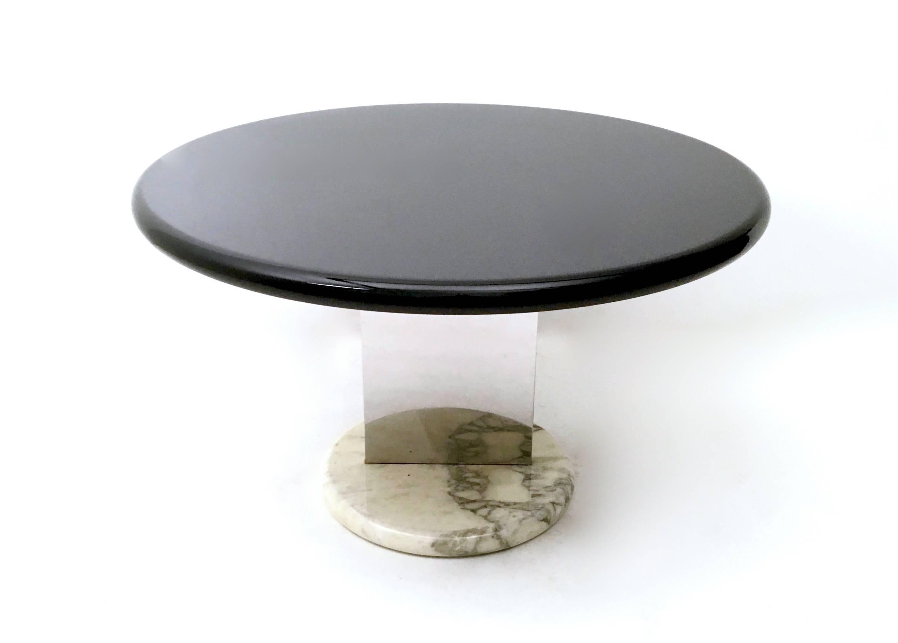 This table is made in Italy, 1970s. 
It has a Carrara marble base, with a double steel lamina and black lacquered wood top. 
Its design is inspired by Ettore Sottsass.
In excellent mint condition.