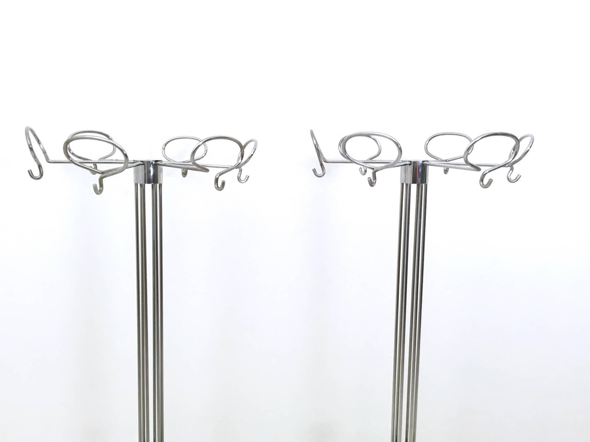 These coat racks are made in chrome-plated metal and feature a metal base covered in plastic. 
They are vintage, therefore they might show slight traces of use, but they can be considered as in perfect original condition.

Measures: Diameter: 47