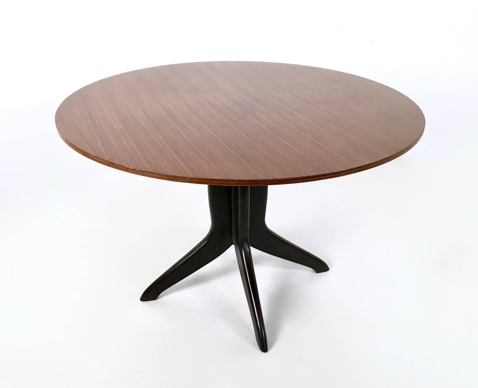 Made in Italy, 1950s.
This beautiful table features an ebonized beech leg and a wooden veneered top. 
It is a vintage piece, therefore it might show slight traces of use, but it can be considered as in excellent original condition and ready to