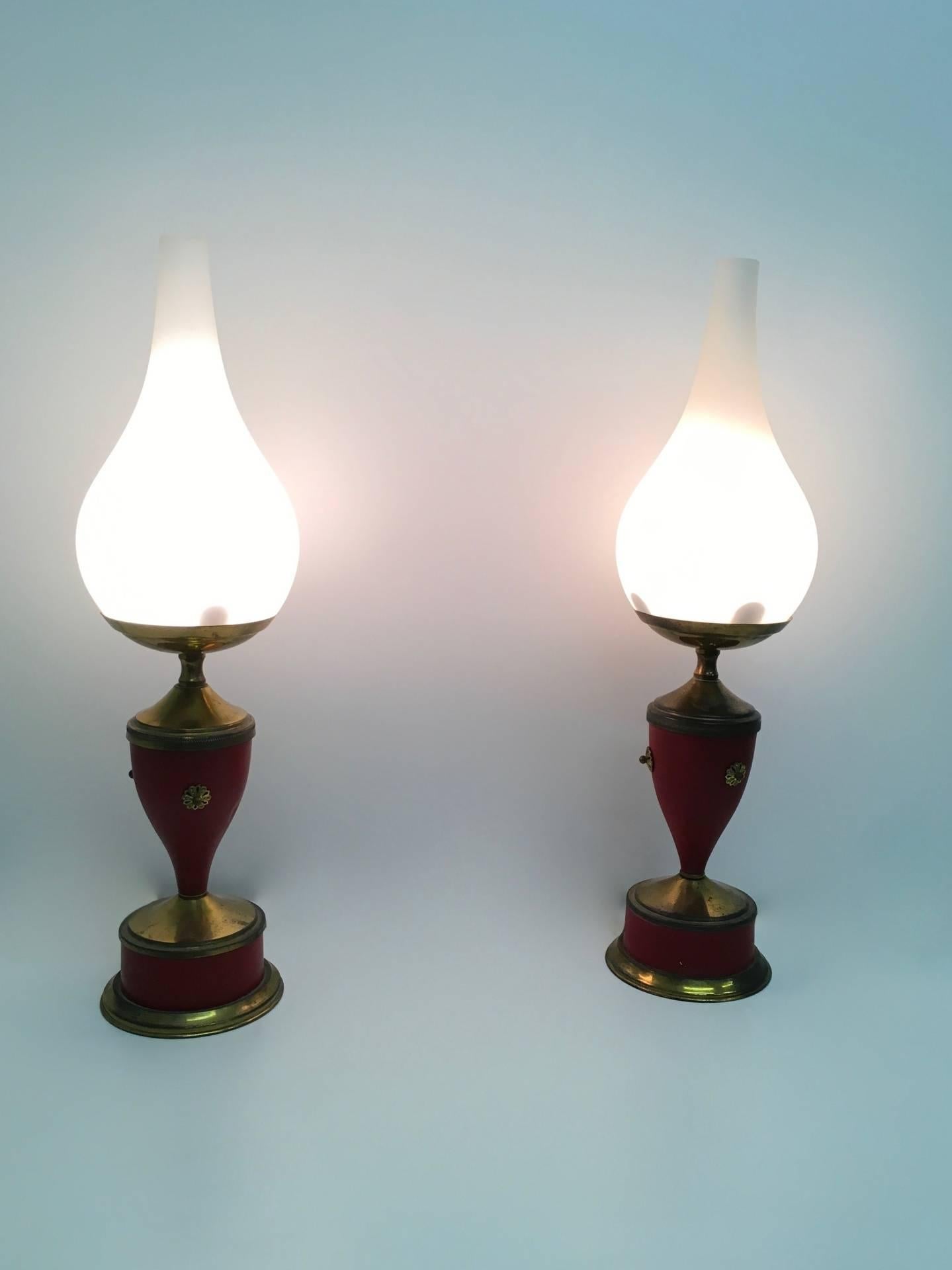 Made in Italy, 1950s. 
These table lamps have a red varnished metal and brass base and an opaline glass shade.
They are vintage pieces, therefore they might show slight traces of use, but they can be considered as in good original