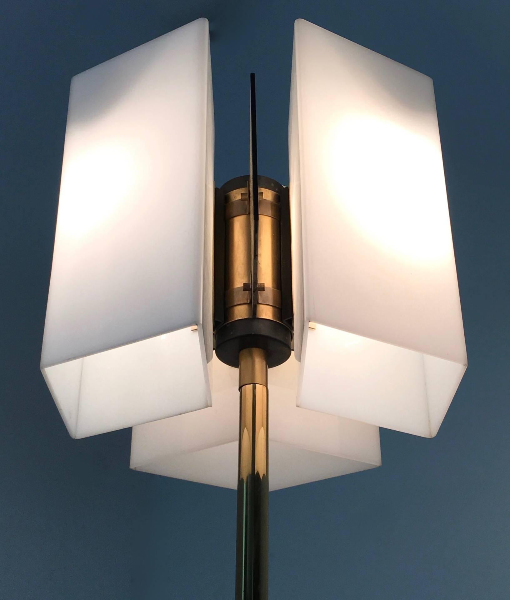 Made in Italy, 1960s. 
This floor lamp features a brass stem and base and a plexiglass shade. 
It is a vintage piece, therefore it might show slight traces of use, but it can be considered as in excellent original condition.

Measures: Diameter: 31