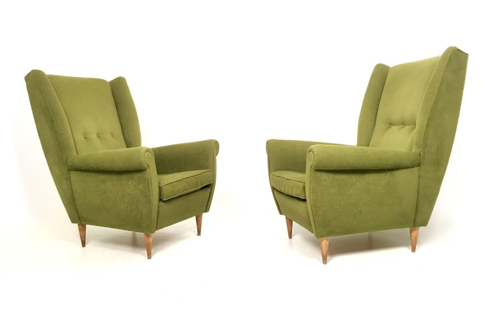 These armchairs are in the style of Gio Ponti.
They feature a wooden structure and are padded and upholstered in vintage fabric, which has no rips or stains.
In very good vintage condition.
Measures: 
Width 72cm
Height 102cm
Depth 91cm.