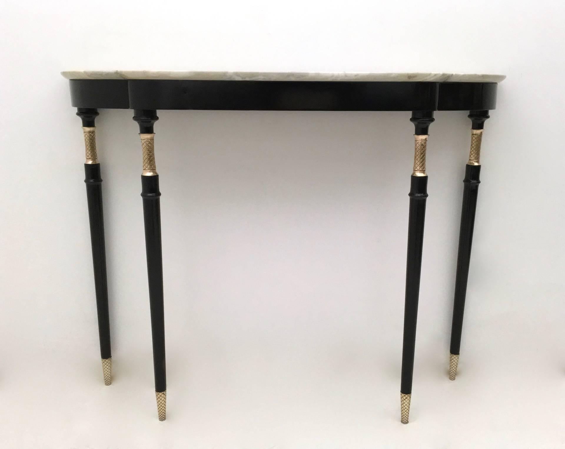 Made in lacquered wood. 
It features a white Carrara marble top and brass feet caps. 
In excellent original condition and ready to become a piece in a home. 

Width: 113 cm 
Depth: 31 cm
Height: 89 cm
