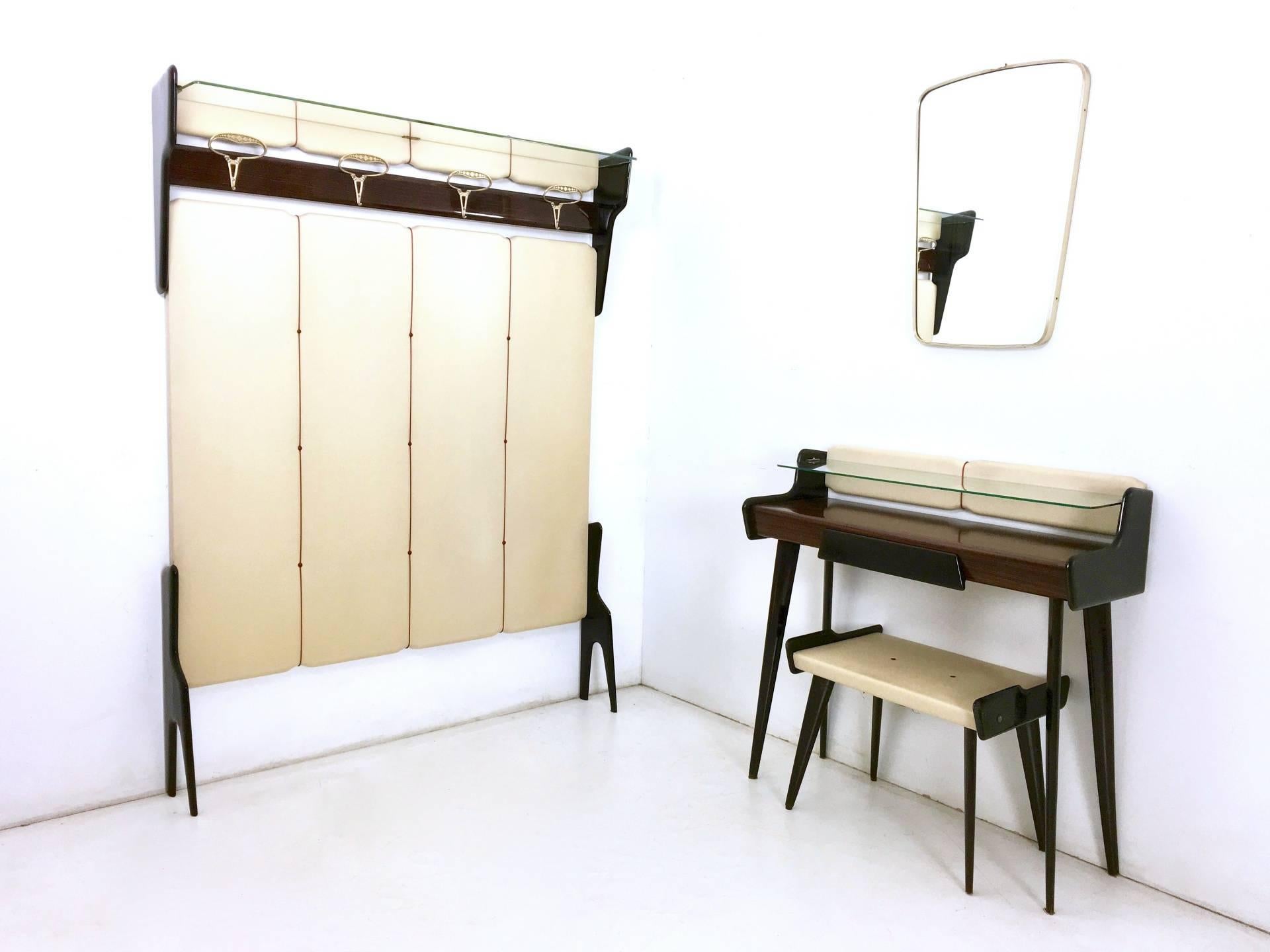 Made in ebonized beech, glass, brass and vintage skai.
In very good original condition.

The coat rack and the wall mirror are for illustrative purposes only (they are available on our storefront on 1stdibs).

Console: 94 x 32 H 92 cm
Pouf: 56 x 39