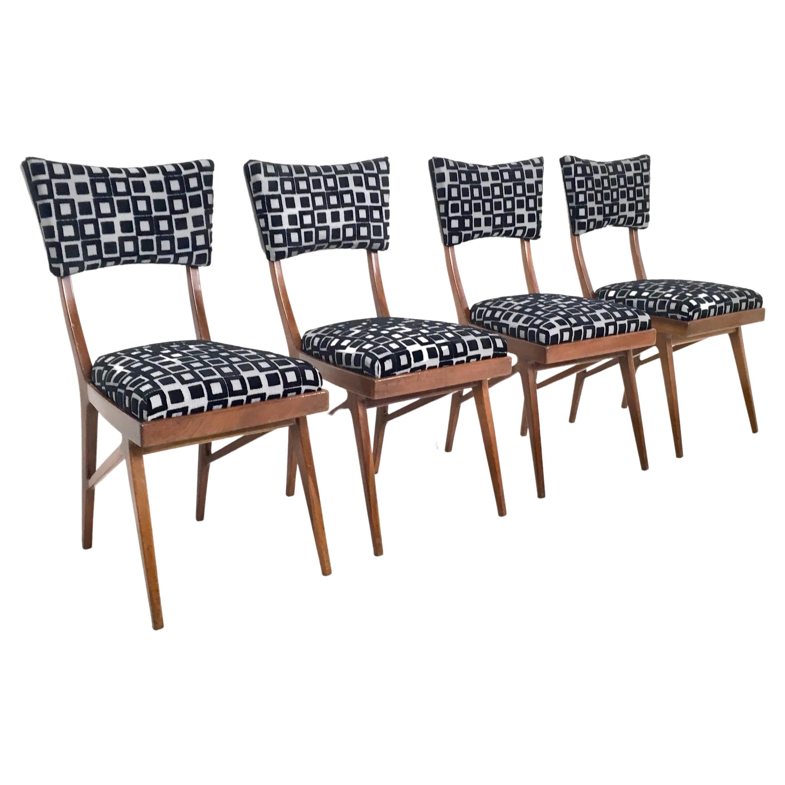 Made in Italy, 1950s.
These chairs feature a solid ebonized beech frame, which has been dyed with a mahogany effect. 
They have been recently reupholstered.
They are vintage, therefore they might show slight traces of use, but they can be