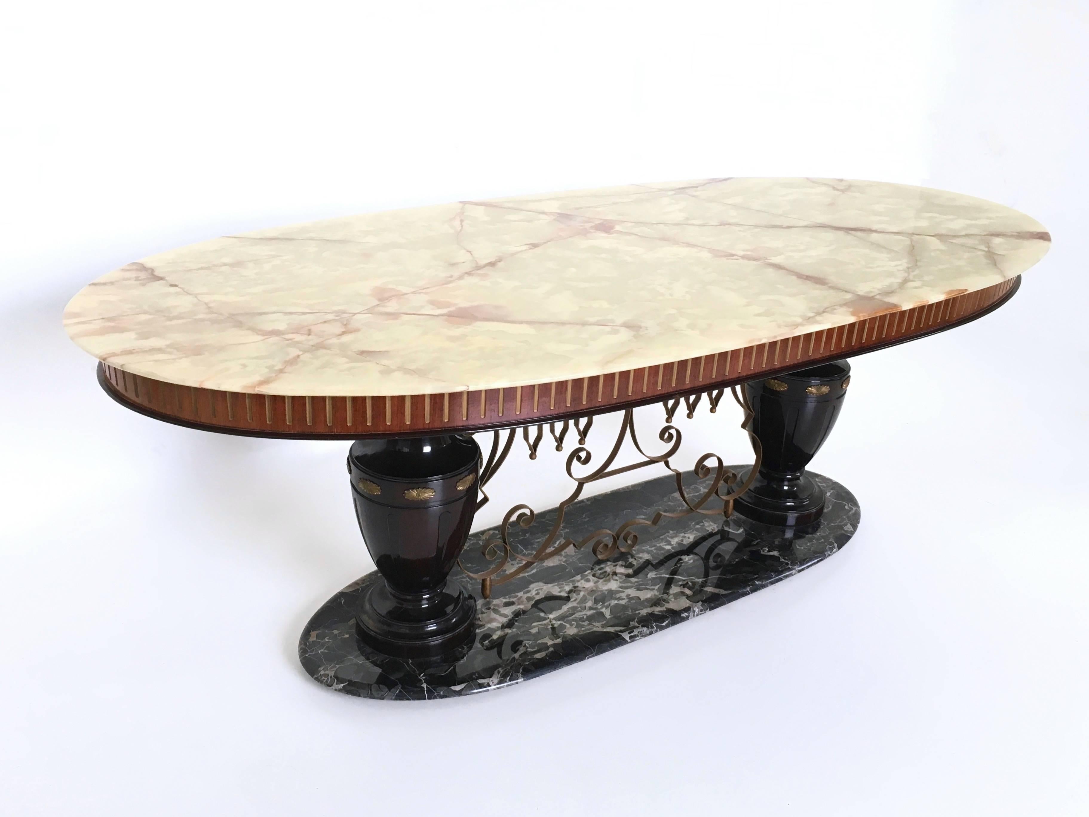 This majestic table is made from onyx and Portoro marble, sitting on turned legs made from lacquered wood, and featuring brass and metal finishing. The edge is made in wood.
It may show slight traces of use since it's vintage, but it can be