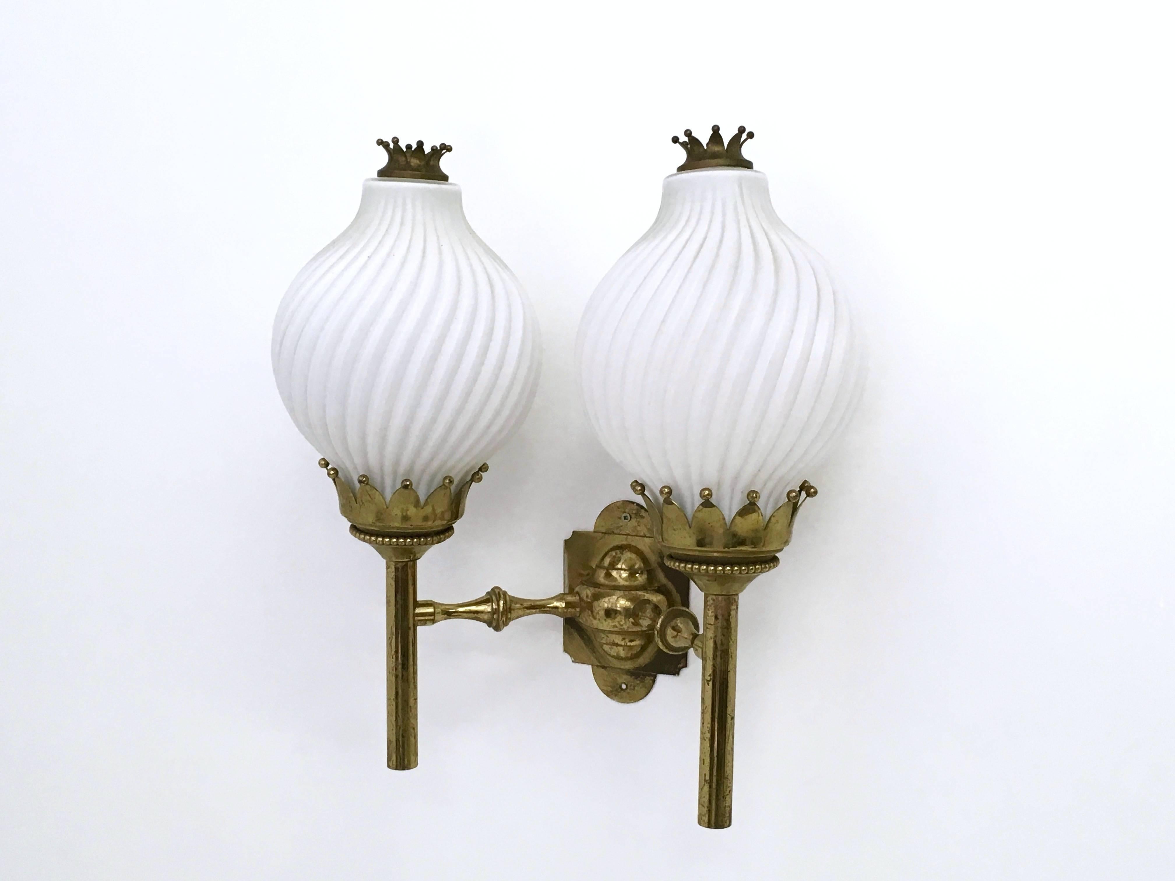 Made in Italy, 1950s.
This sconce is made in brass and opaline glass. 
It may show slight traces of use since it's vintage, but it can be considered as in very good original condition and ready to give ambiance to any room.
It features its original