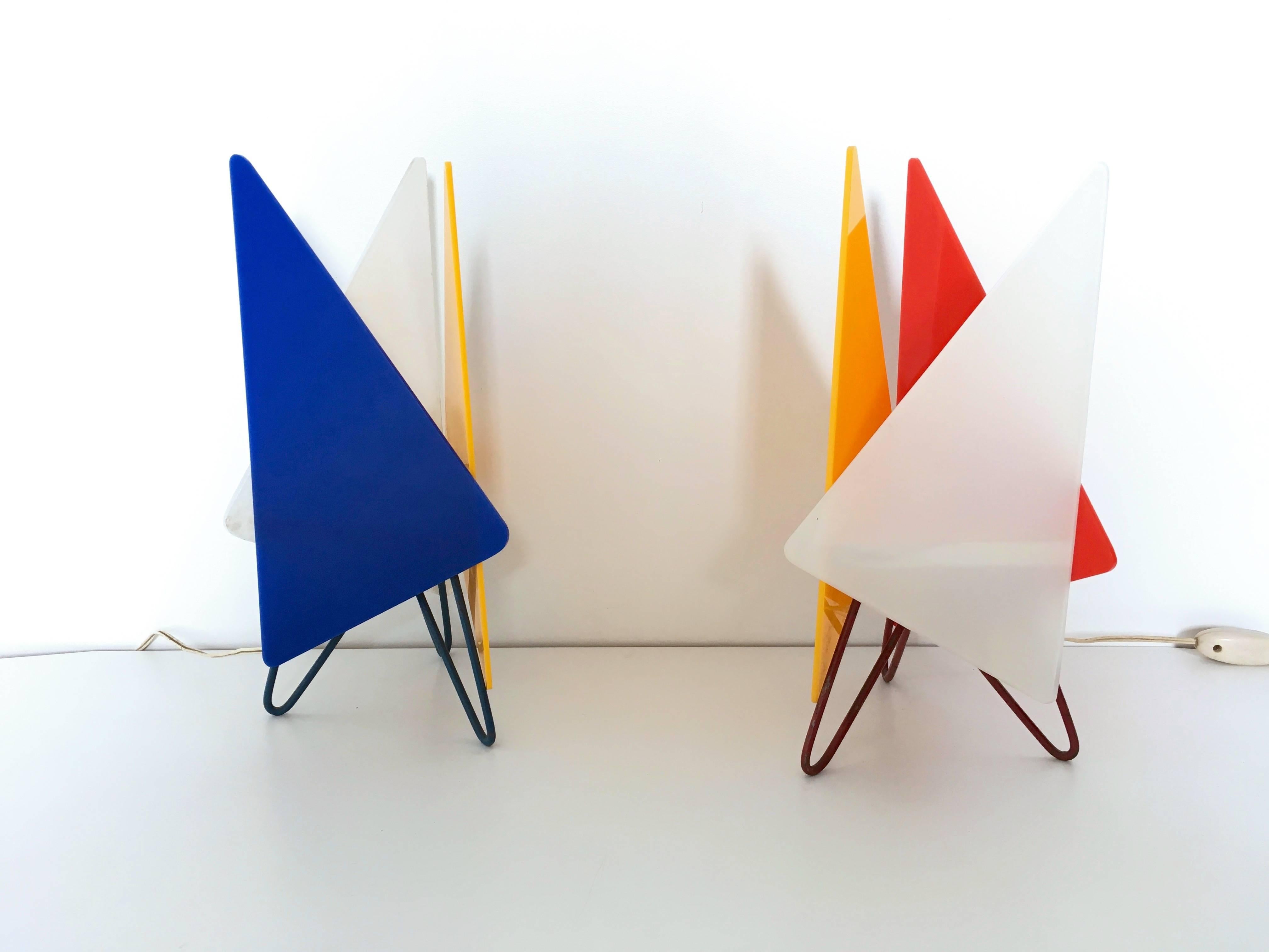 This pair of 1950s table lamps are made from colored plexiglass and painted iron.