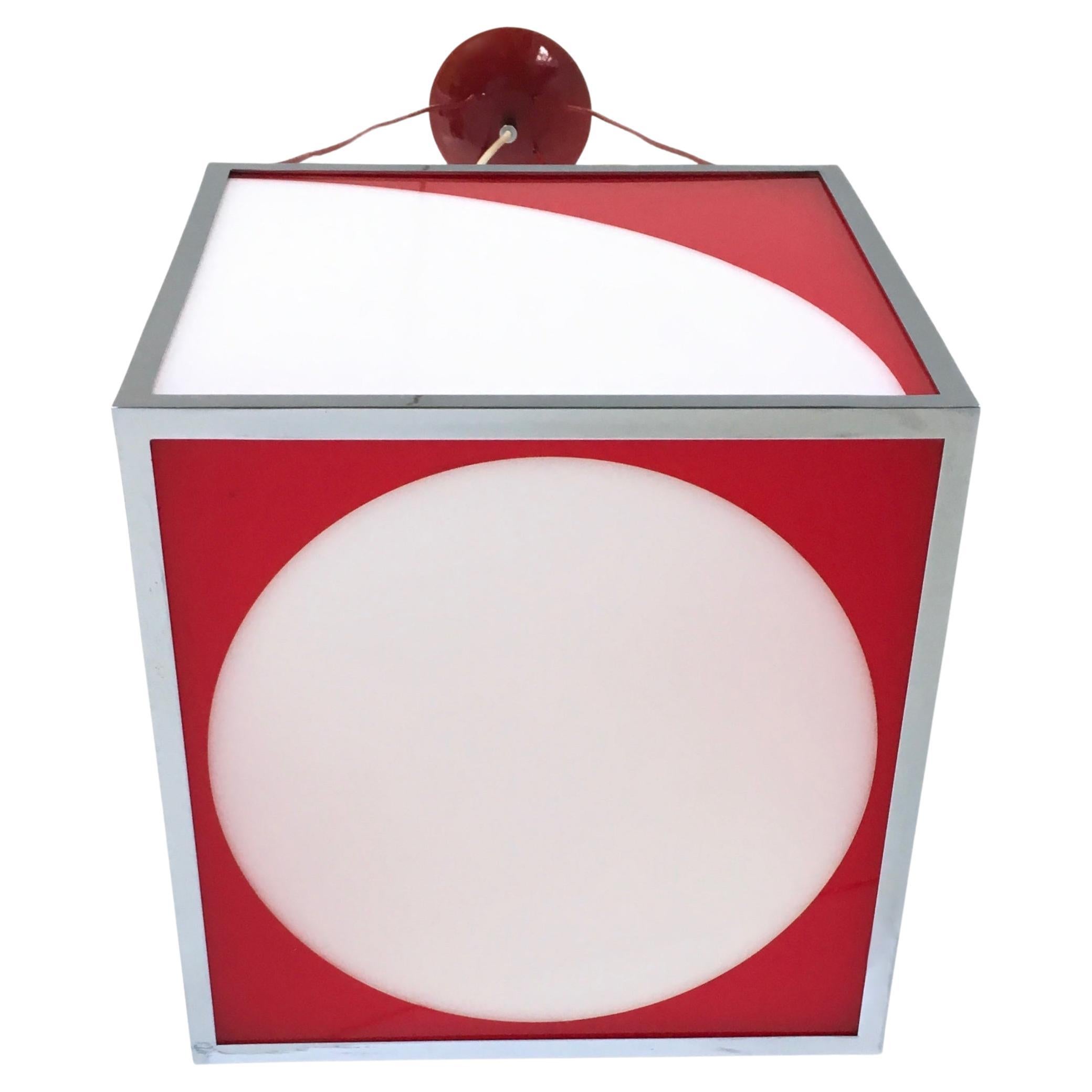 Made in Italy, 1970s. 
This pendant features a cubic red and white plexiglass shade and a chrome-plated and varnished metal frame.
It has its original wiring covered in red rubber.
It is a vintage piece, therefore it might show slight traces of use,