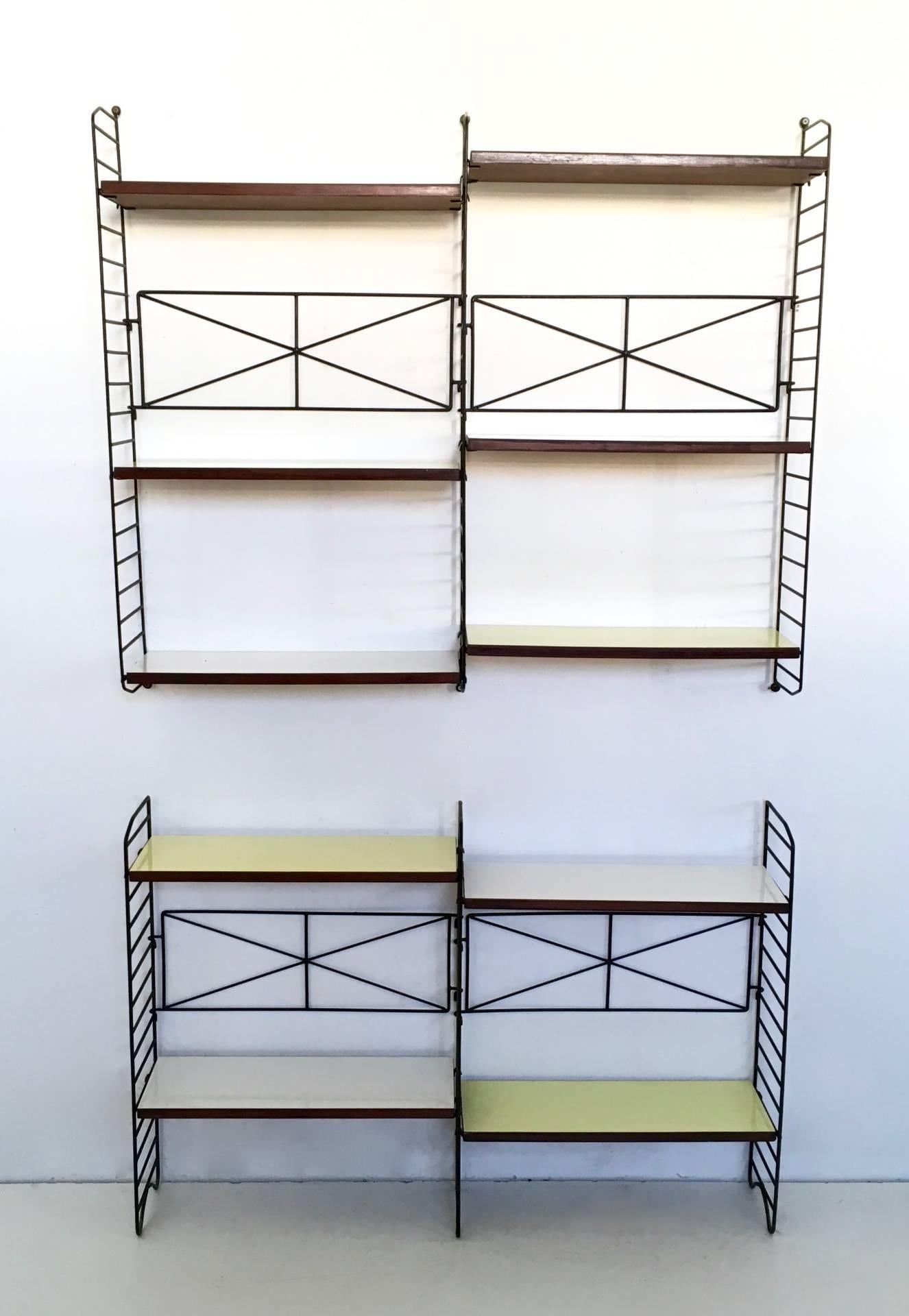 This Minimalist bookshelves has two components and one of them is wall-mounted. 
Dimensions are variable, as the shelves are movable. 
They have a metal structure and wooden shelves covered in formica. 
In excellent original condition.