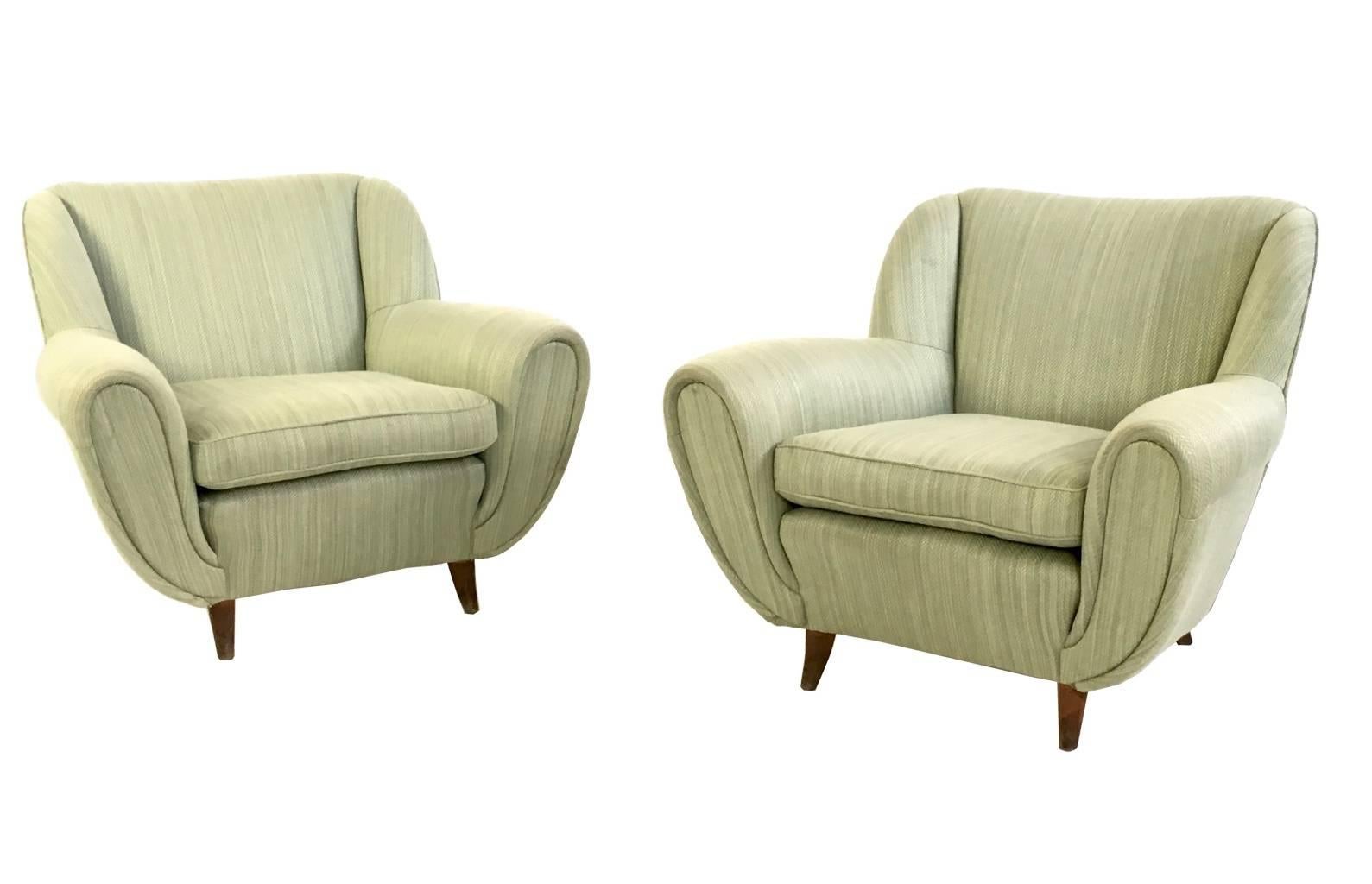 Made in Italy, 1950s. 
They feature a wooden structure, which is padded and upholstered in light green fabric.
These armchairs are vintage therefore they might show slight traces of use, but they can be considered as in excellent original condition