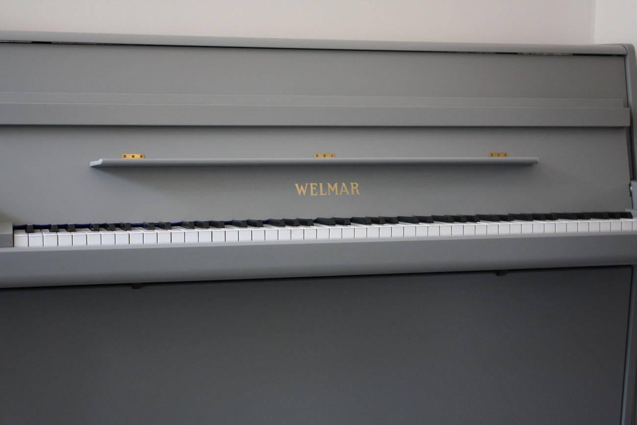 A Classic looking upright piano from Welmar; Welmar pianos had a long history of making good quality pianos and are well respected in the piano trade. This model has a good medium touch and clear resonant tone with warmth. It has been refinished in