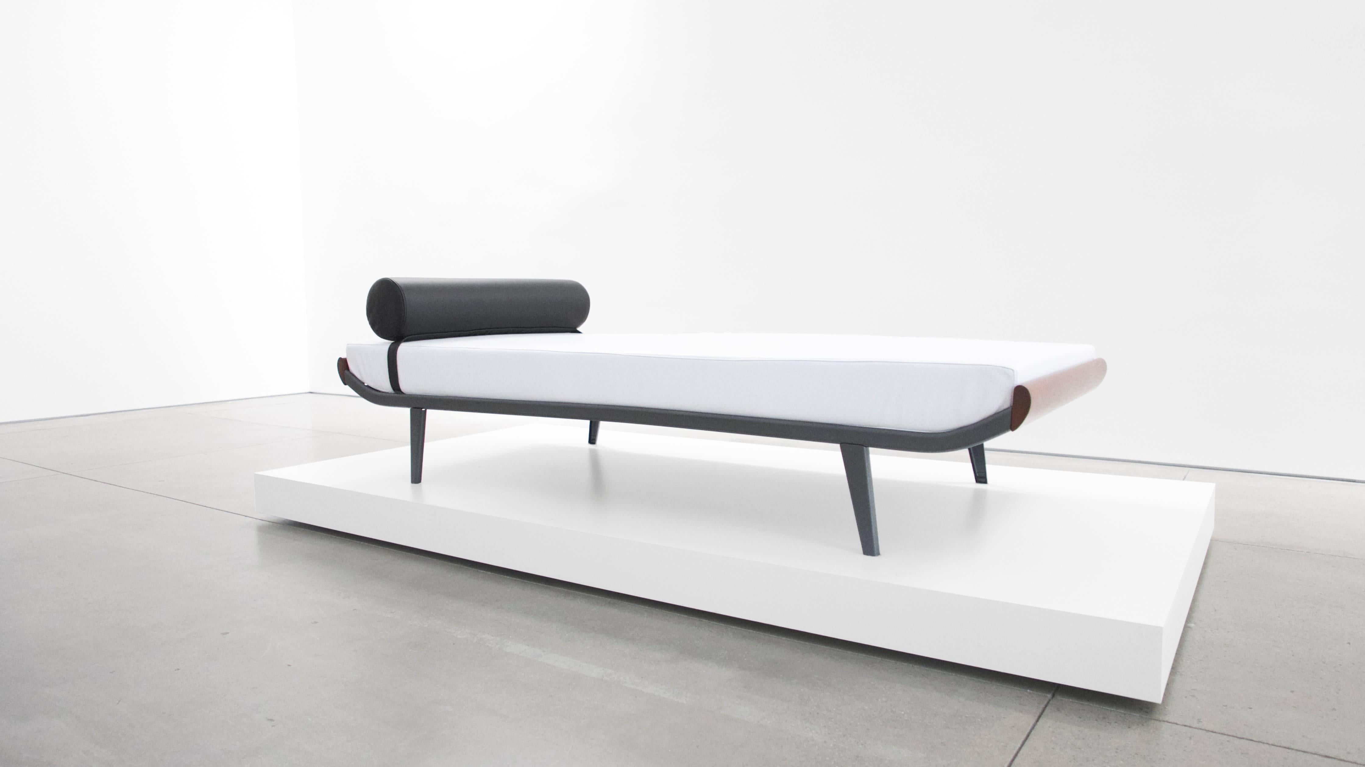 1960s Cleopatra style daybed by A. R. Cordemeier. Teakwood ends with powder-coated black metal frame. New white leather upholstered mattress and black leather bolster.