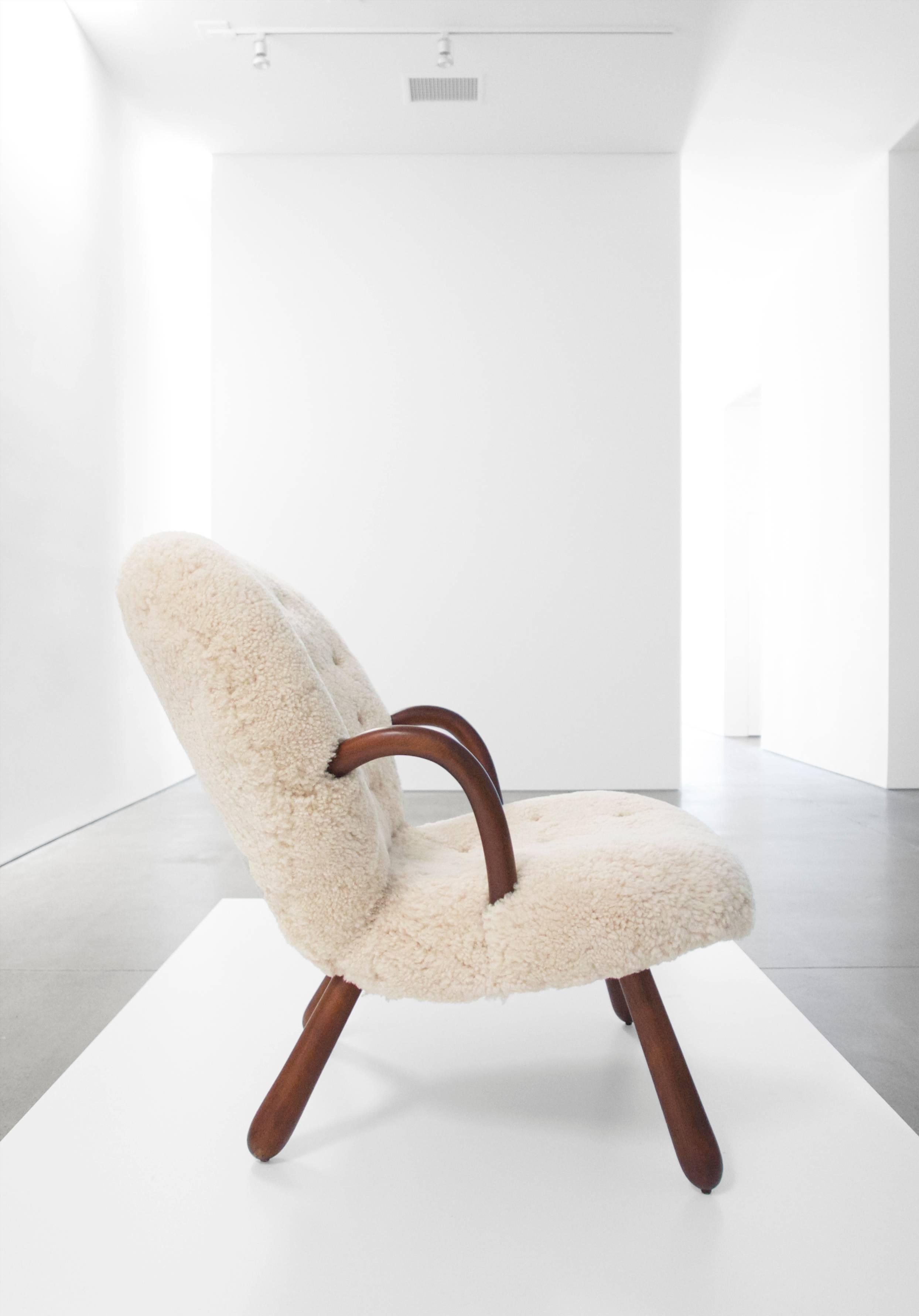 Philip Arctander "Clam" chair with legs of birch, upholstered in sheepskin.
    
    