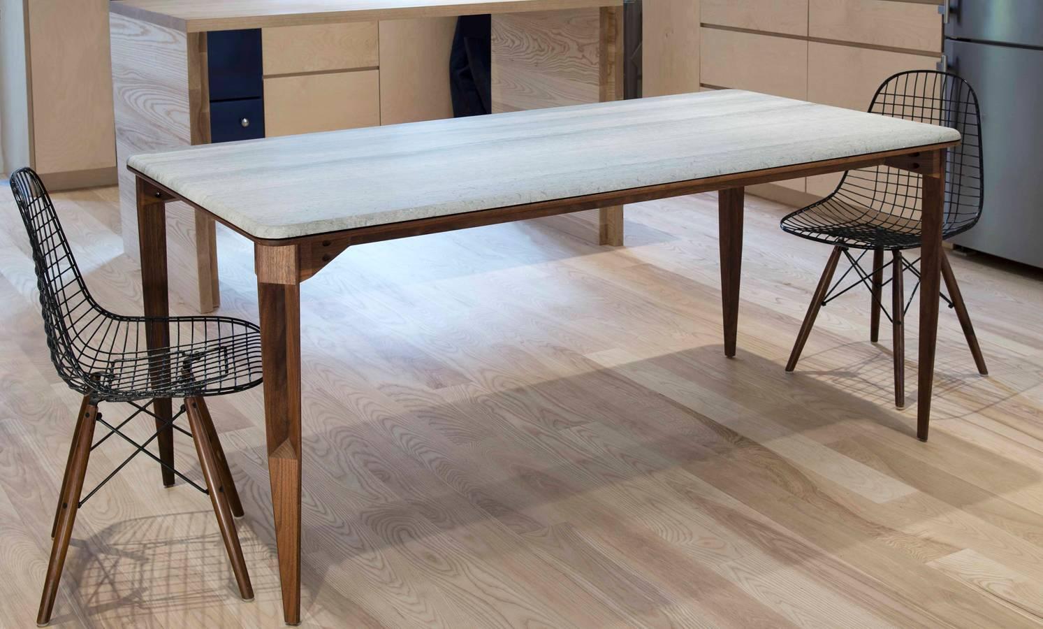The brindle table provides a striking balance between density and lightness. The weight of the marble floats atop a lean structure of walnut. The marble's honed surface is rich in tone and pattern and offers a beautiful support for special occasions