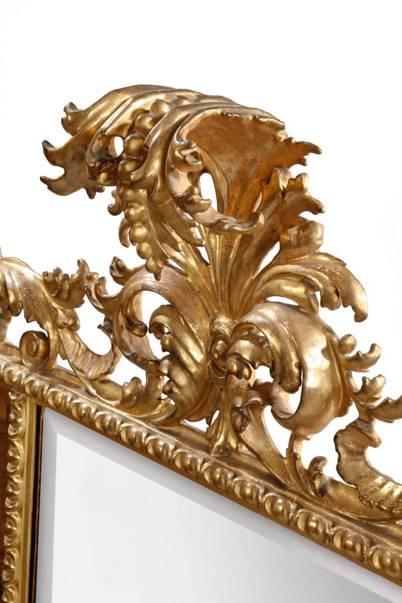 Of excellent quality, this mirror retains all the original wood carving and gilt decoration. Normally one only sees much smaller wall brackets in this style and it is very unusual to find a mirror of this scale and originality. The three beveled