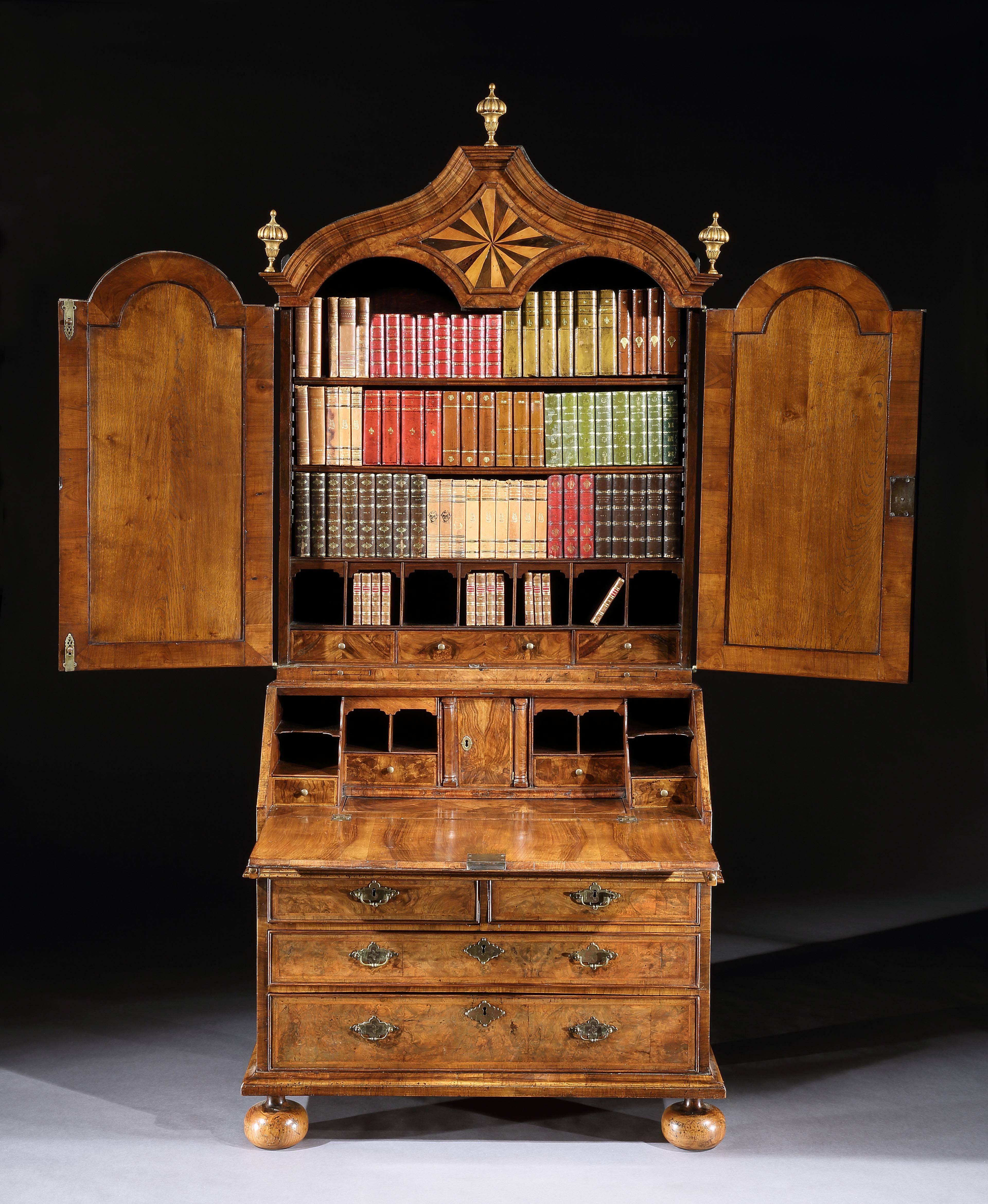 Dating from the late 17th century, this mirror plated, domed bureau bookcase is veneered in figured and burr walnut. The twin mirrored doors open to reveal a top part with drawers, pigeon holes and adjustable shelving. The base with an interior