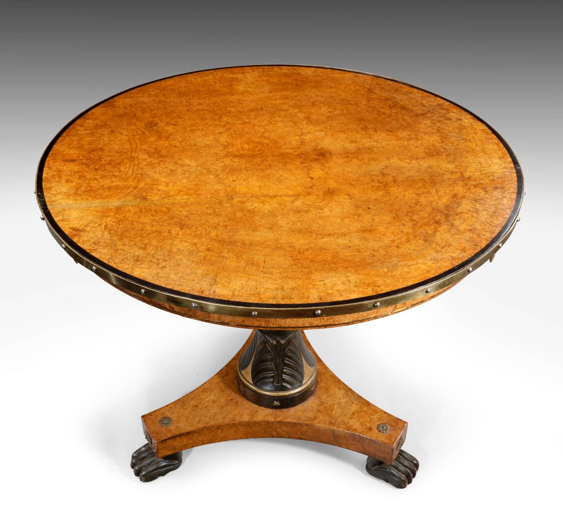Of super quality, this burr amboyna table has a decorated column and applied brass lion ring masks to the top as well as a brass rim moulding. It is a really great colour and is ideal for use as a centre table or an occasional table. From its style