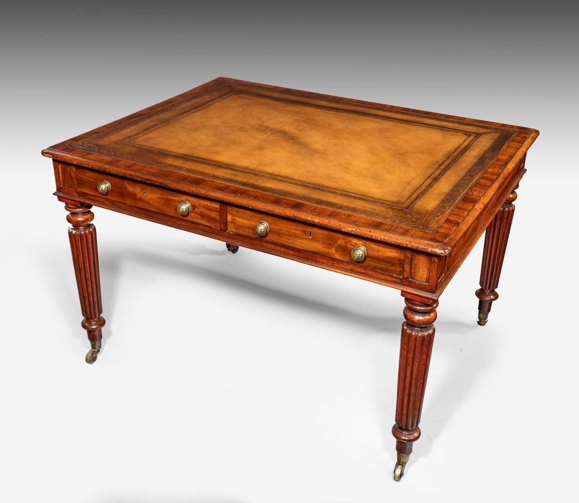 Made from Cuban mahogany, the table is of first class quality. It has twin drawers one side and dummy the other. The crossbanded top borders a leather that is a great color and the table is an unusual proportion being more square in form than the