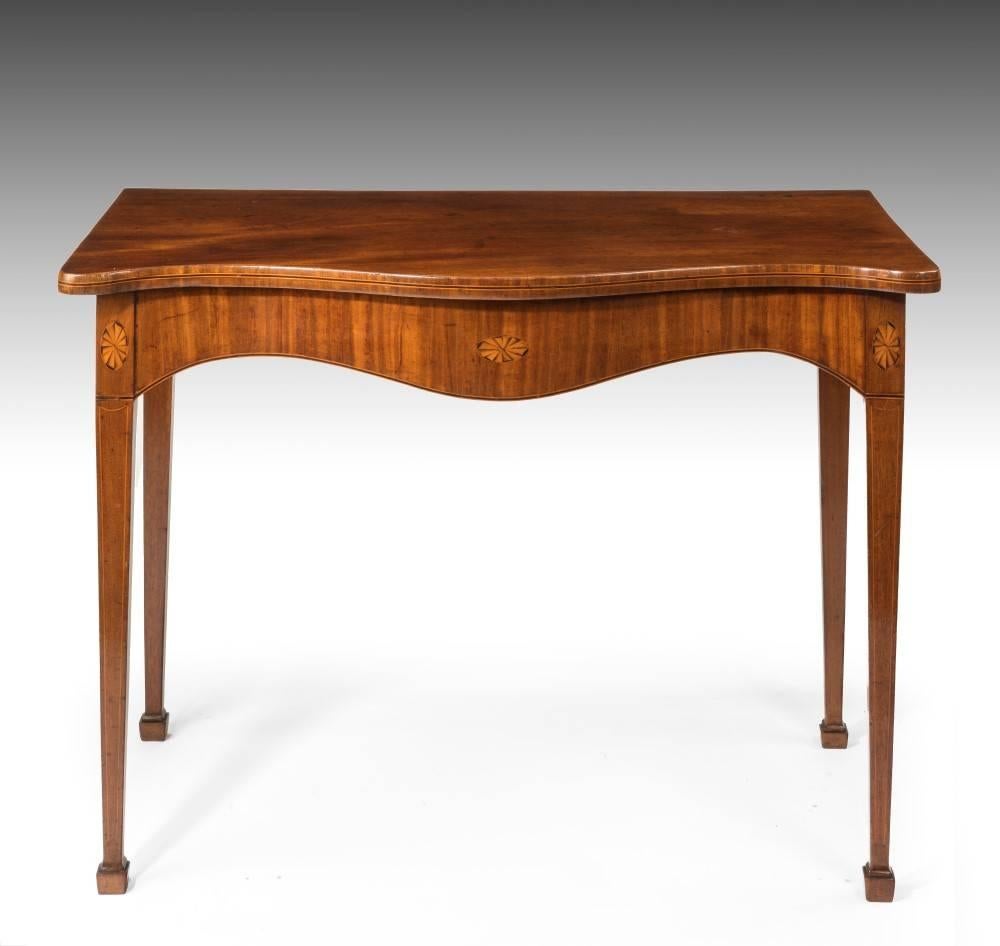 Made from Cuban mahogany, this table dating from the late 18th century is of good quality and color. It has inlaid marquetry fans and stands on elegant tapering legs with block feet. It is currently in our Charleston location.