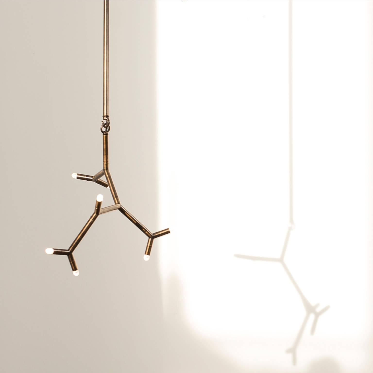 Exhibiting a primary element in repetition, the Ursa Minor pendant takes inspiration from both molecular forms and constellations. The modern pendant offers multiple points of light on an intimate scale, a focal point in open space. This light