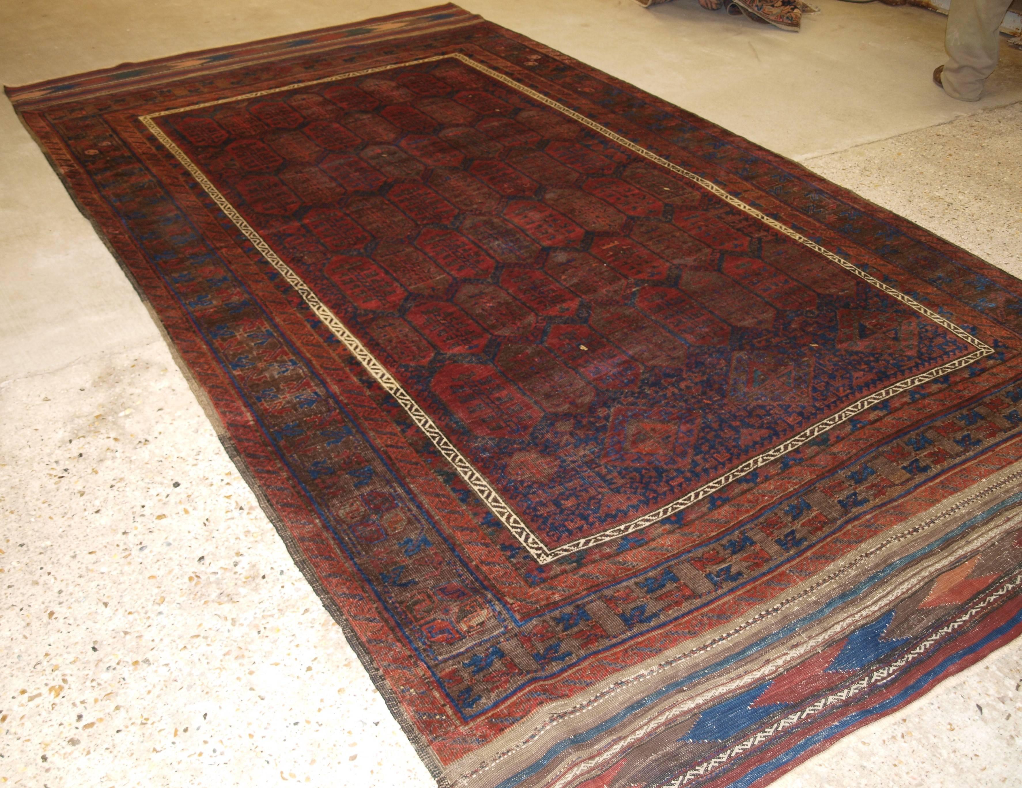 Size: 12ft 2in x 6ft 7in (370 x 200cm).

A good antique main carpet by the Baluch of western Afghanistan. The carpet is of the shrub design with a traditional Baluch border, 

circa 1870.

The carpet has the traditional dark indigo ground and