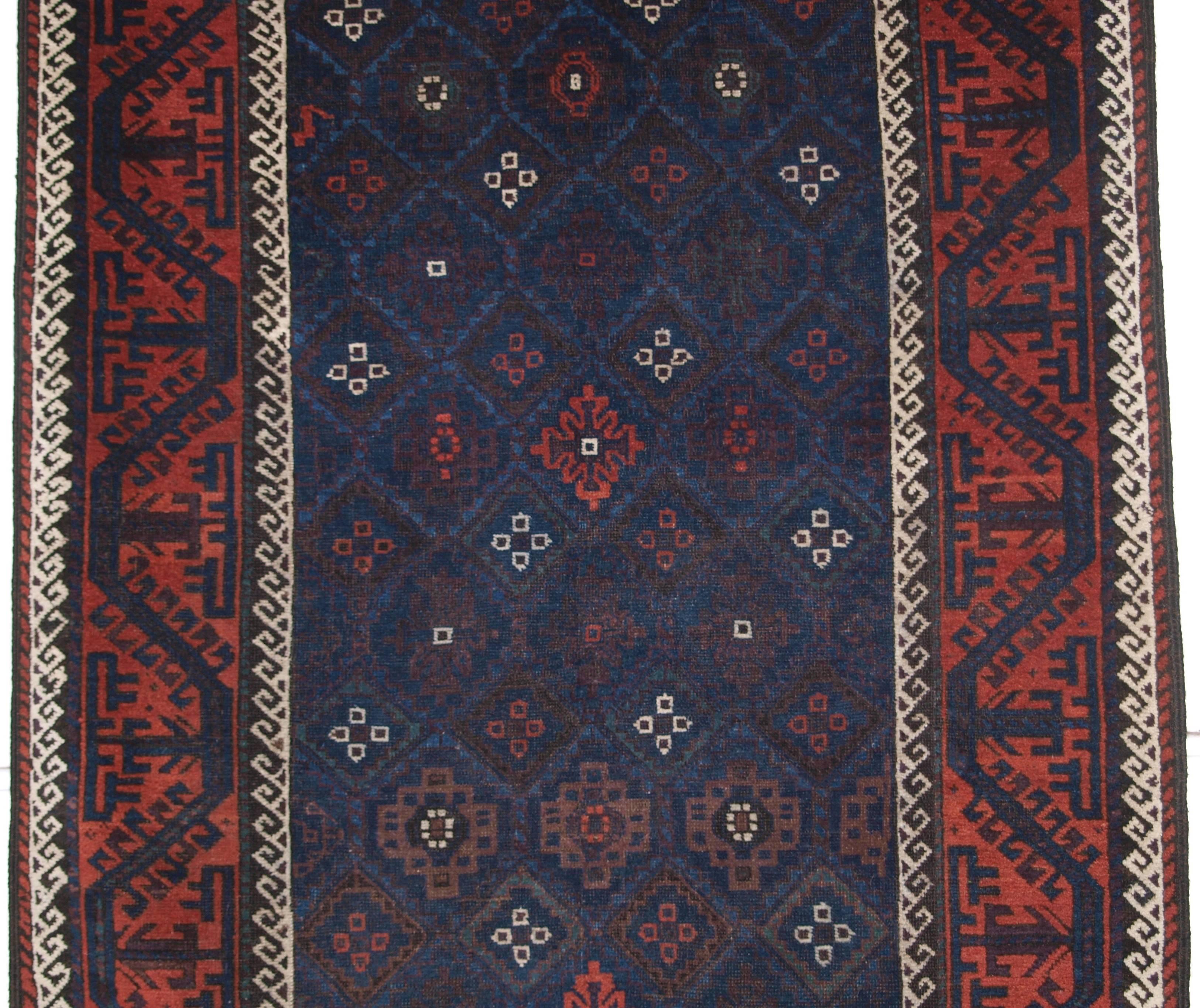 Size: 6ft 11in x 3ft 8in (212 x 112cm).

Antique baluch rug from Western Afghanistan / Eastern Persia. A Baluch rug with a very unusual lattice design in blue,

circa 1880.

A superb Baluch rug with a diamond lattice design with mina khani