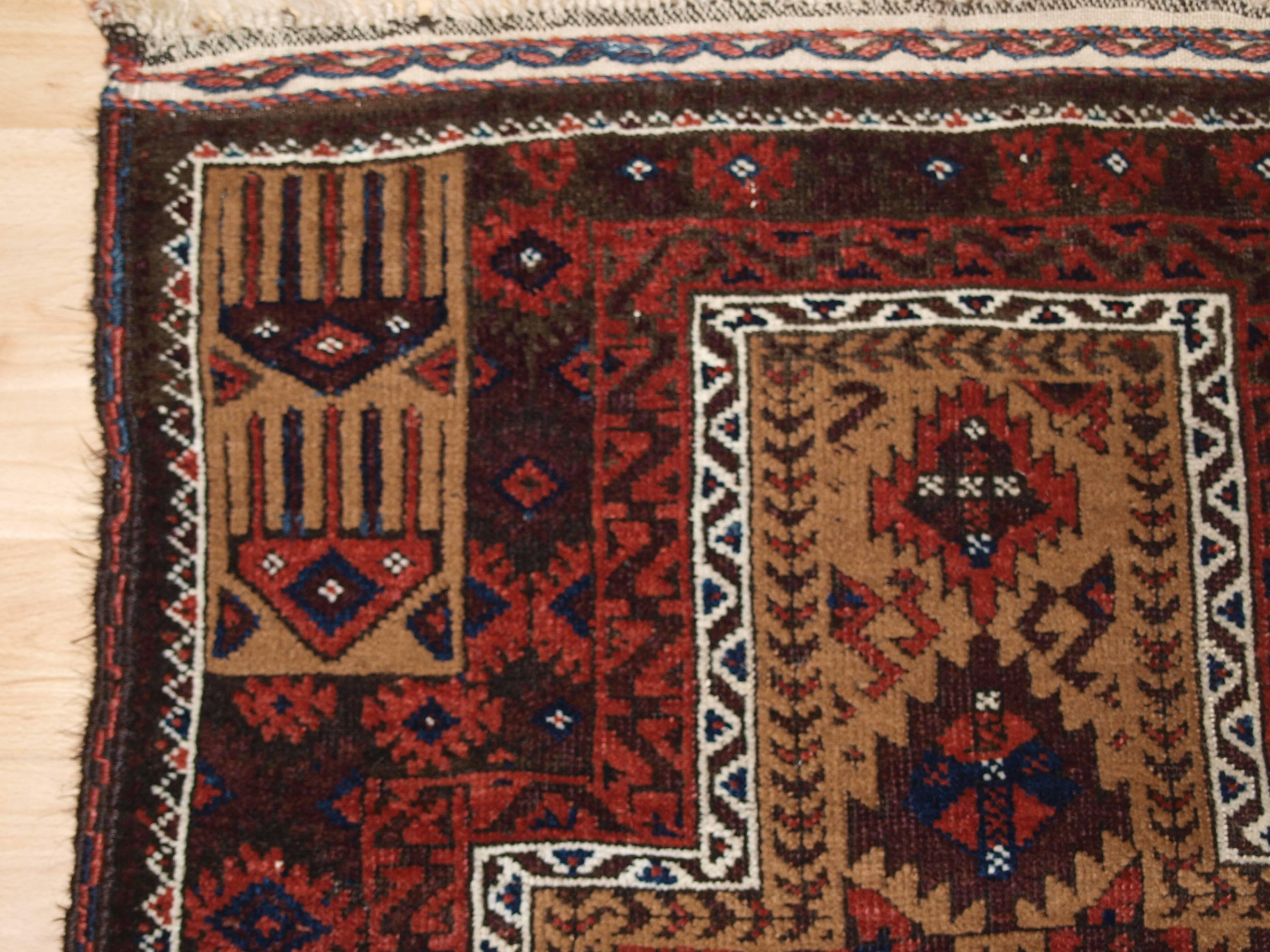 Antique Baluch camel ground prayer rug with interesting Turkmen inspired design. 

Size: 5ft 3in x 2ft 8in (160 x 82cm),

circa 1900.

The rug is beautifully drawn and has excellent color, the camel wool ground is very soft. The rug retains