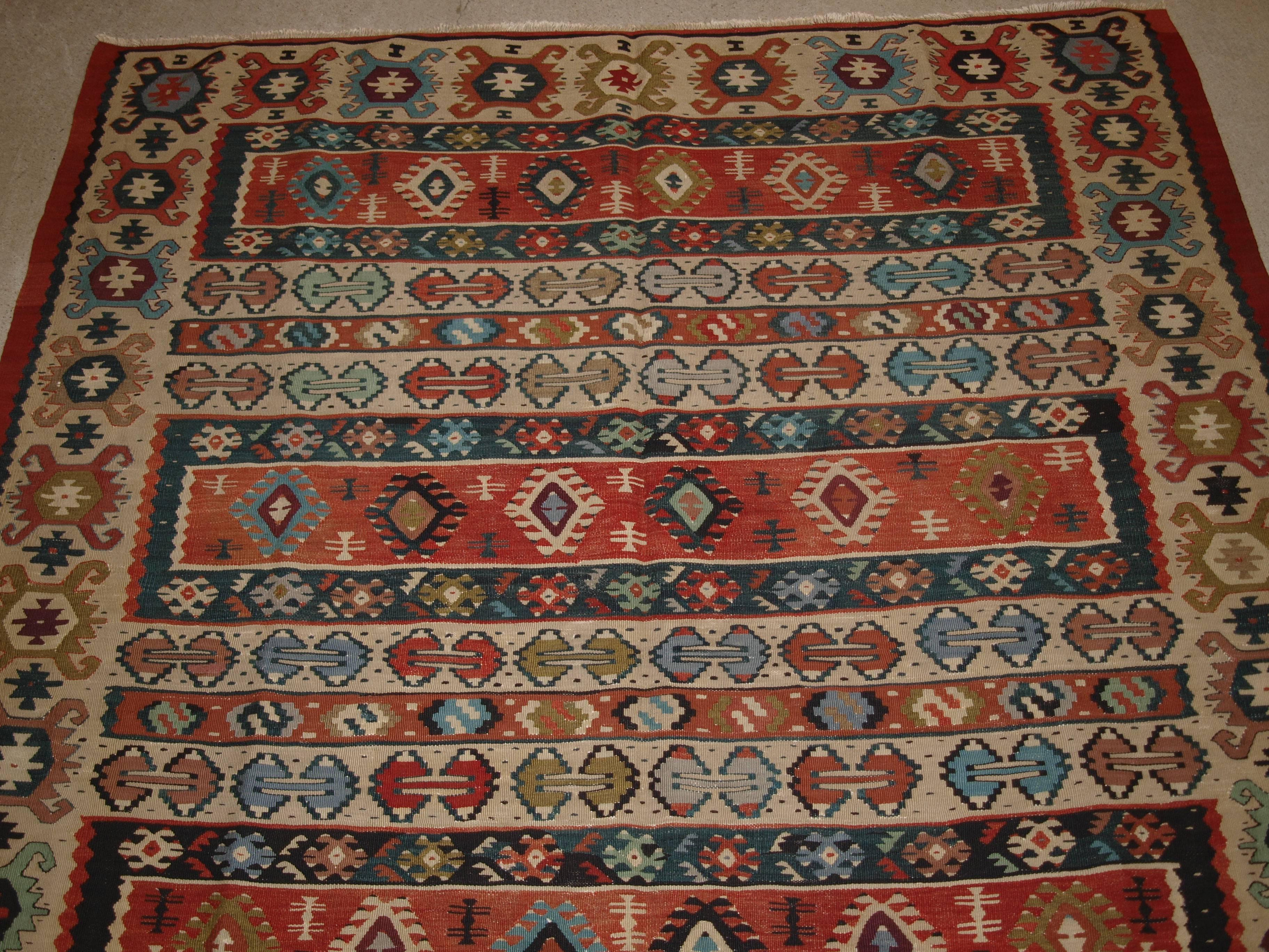 Old Turkish Sarkoy Kilim rug, ivory border, banded design, superb colours, circa 1920.
Size: 8ft 2in x 5ft 0in (248 x 153cm).

Old Anatolian Sharkoy Kilim, Western Turkey

circa 1920

Sharkoy kilims are also known as Sarkoy or Thracian, they