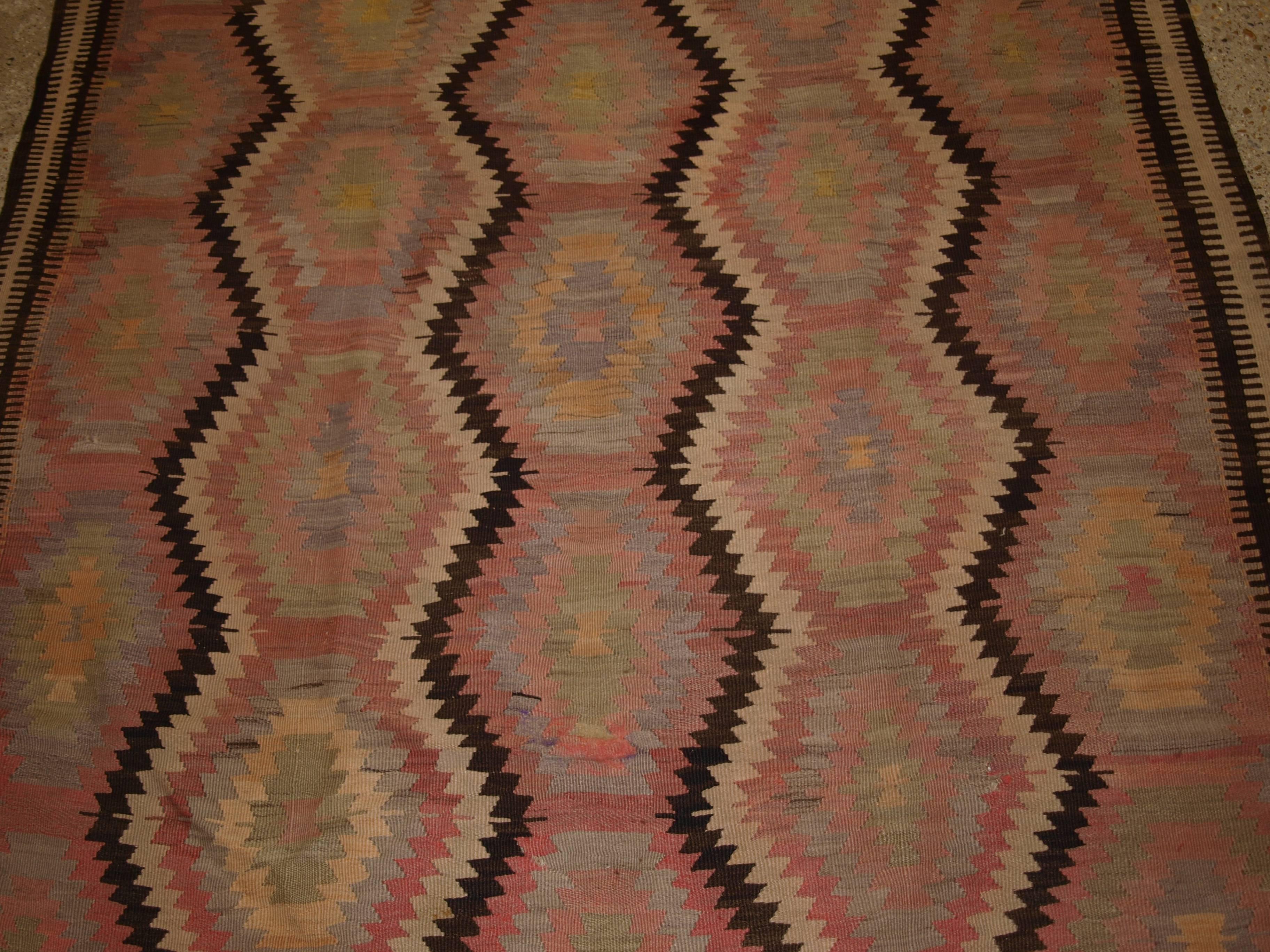 Old Turkish Fethiye Kilim, eye dazzler Design, soft pastel colors, circa 1920.
Size: 10ft 1in x 4ft 10in (308 x 147cm).

Old Turkish Fethiye region Kilim from south west Anatolia, a Kilim with very soft faded colours.

circa 1920.

Classica