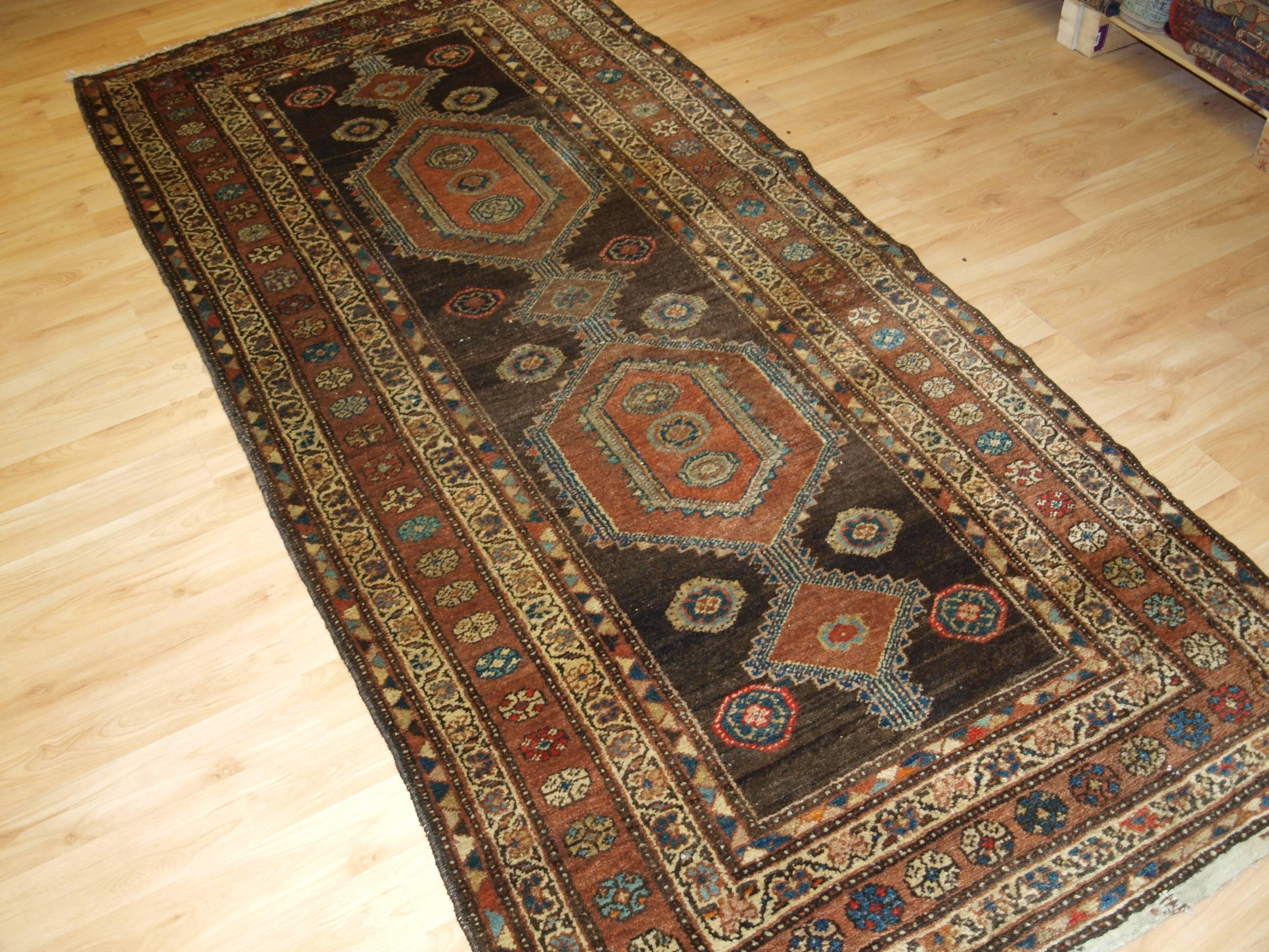 Wool Antique Kurdish Long Rug with Linked Medallion Design, circa 1900 For Sale