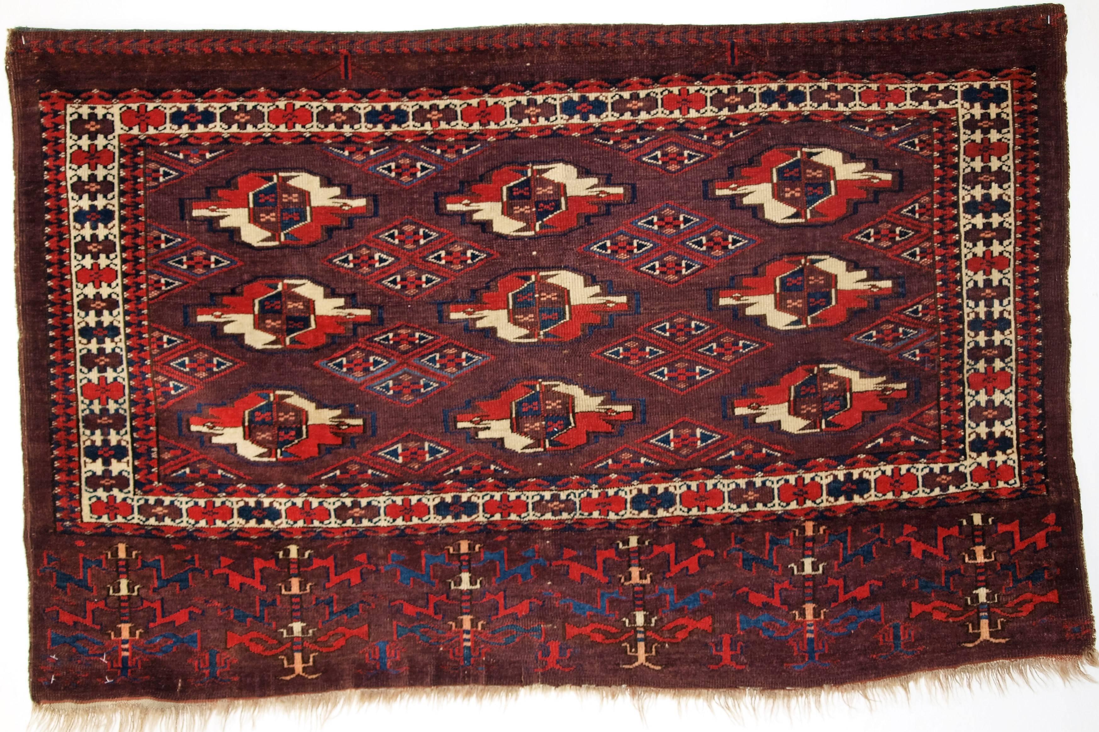 Antique Yomut Turkmen 9 Gul Chuval, great color, superb elem design, circa 1870.
Size: 3ft 11in x 2ft 6in (120 x 75cm). 

Antique Yomut Turkmen 9 gul chuval with superb rich colour. Note the well drawn 'bat' border. The elem design is really