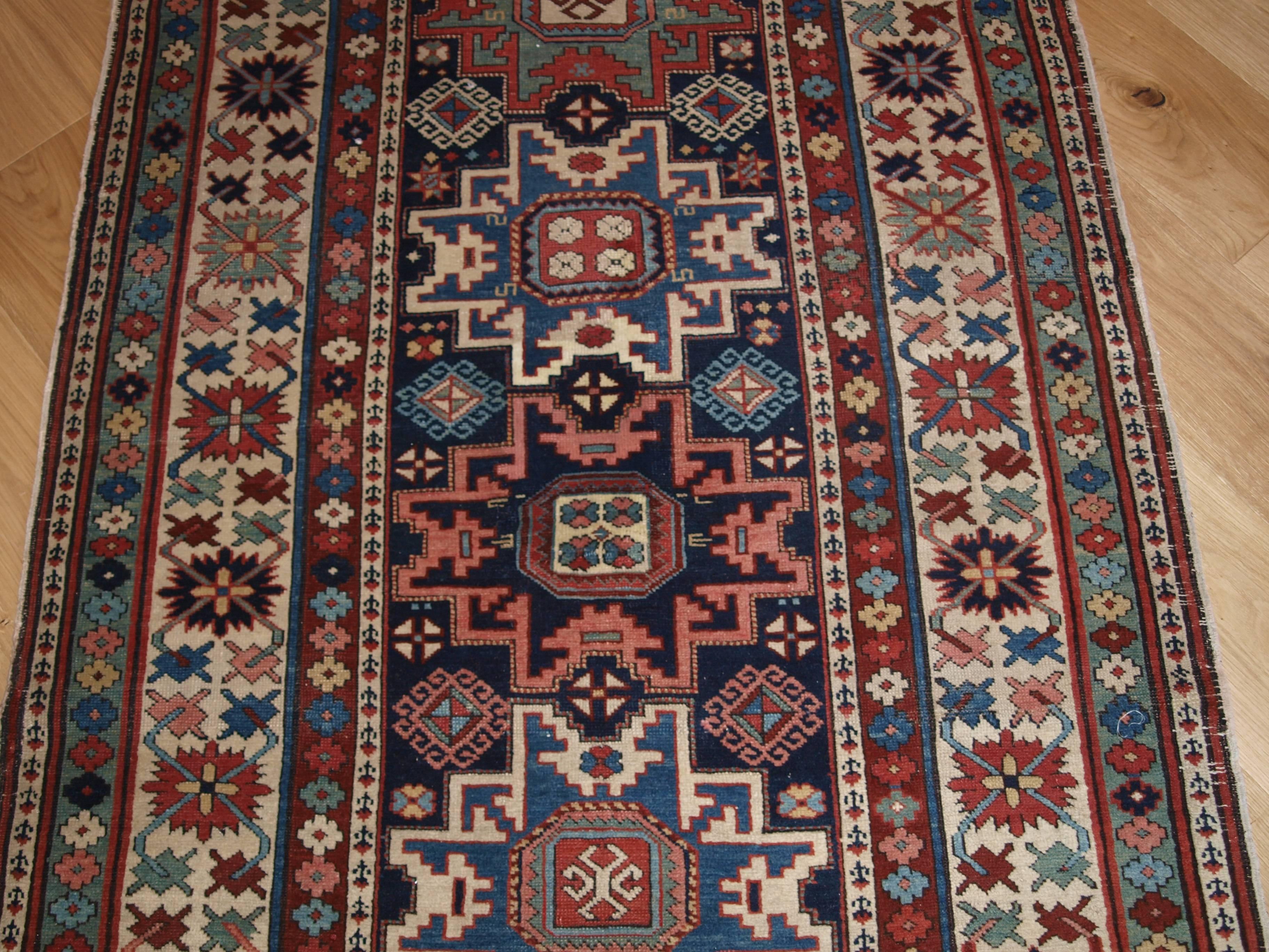 Antique Caucasian Shirvan runner with lesghi star design, fine weave, superb colors, circa 1880.
Size: 9ft 11in x 3ft 6in (302 x 108cm).

A very good example of a Shirvan runner, fine weave and outstanding colors. The field is a repeat medallion
