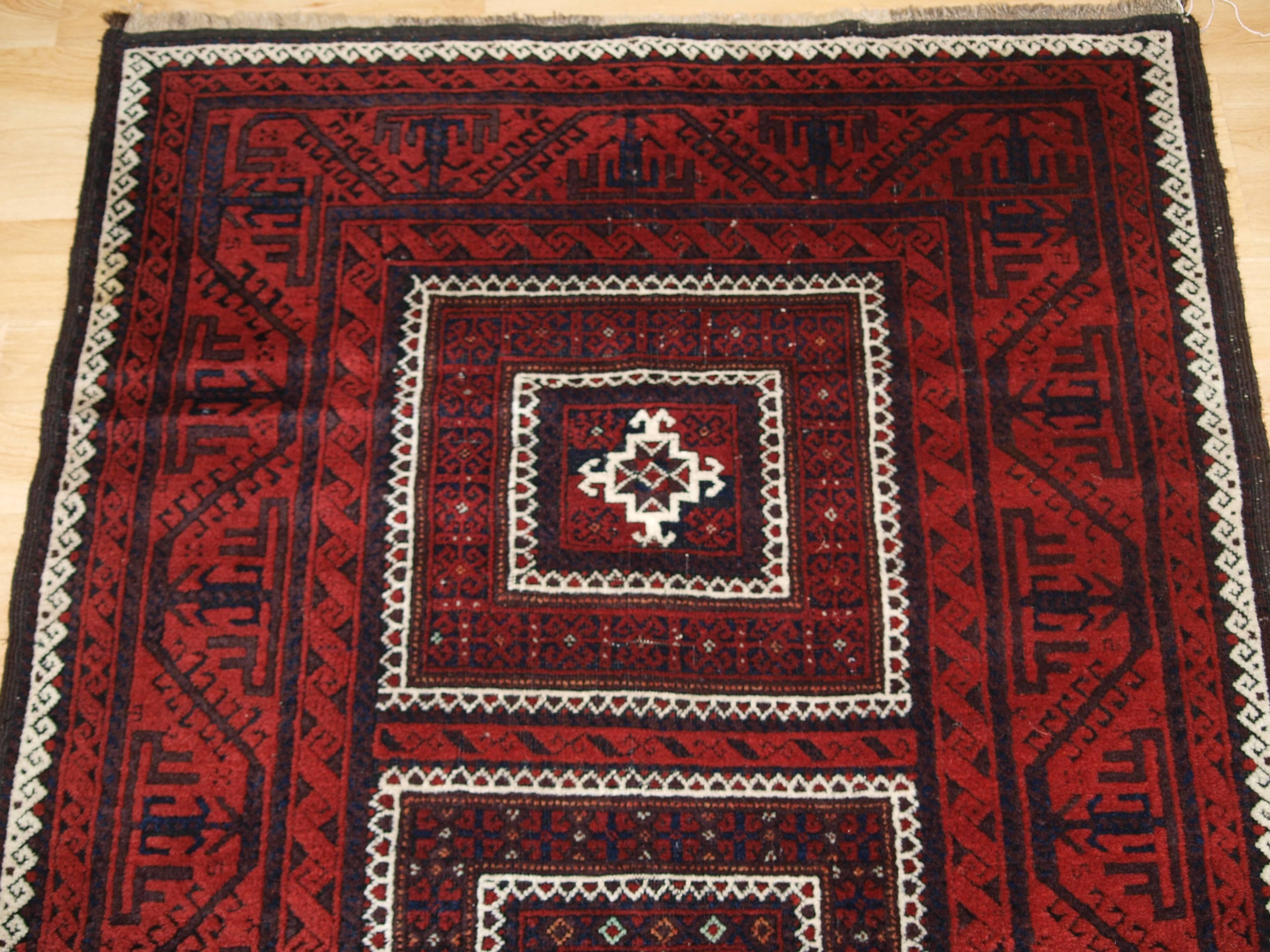 Size: 6 feet 1in x 3 feet 3 in (185 x 100cm).

Antique Baluch rug with three compartments. A Baluch rug with good traditional Baluch colours with a traditional Baluch boat border,

circa 1900.

A good Baluch rug with interesting design, the