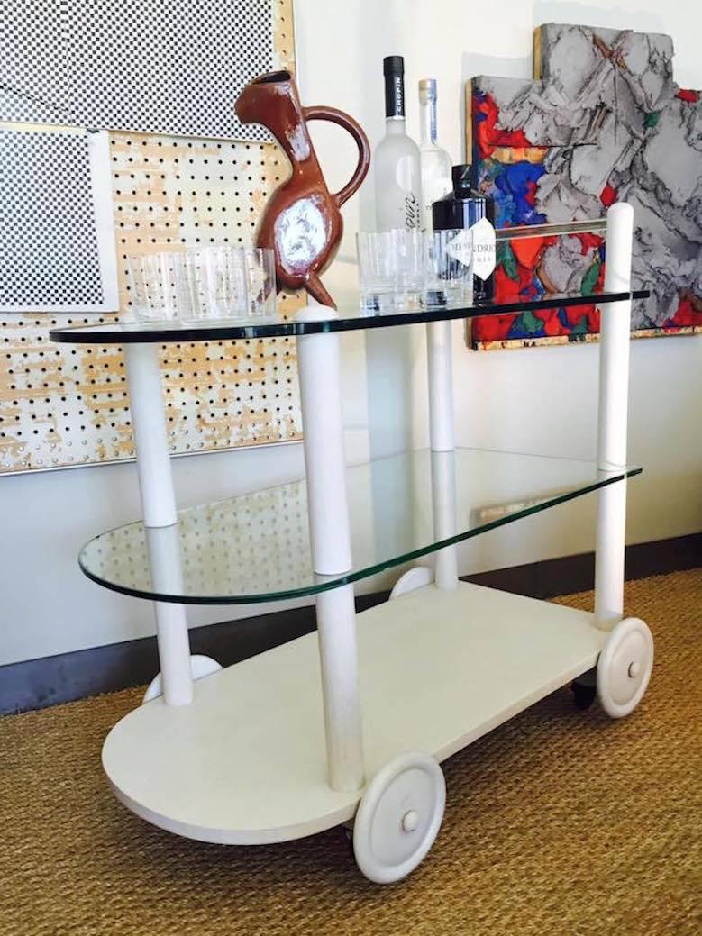 Handsome cocktail cart with multiple glass shelves and glass handle. 
Nice size, in excellent condition.Herman Miller produced some of the most beautiful, iconic and, one can even say, noblest furniture of the past seven decades. In 1932  Gilbert