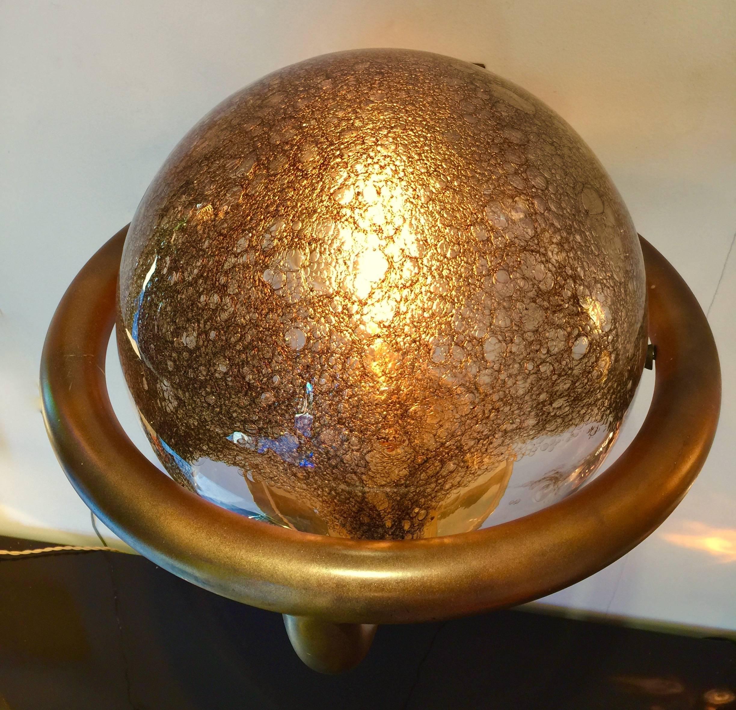 Big pair of Mid-Century Modern or space age wall light sconces in Murano blown glass and mordore lacquered metal. Brass base. The glass is blown with iron oxides which gives it a golden, mordore color and bubble in the glass, typical of the