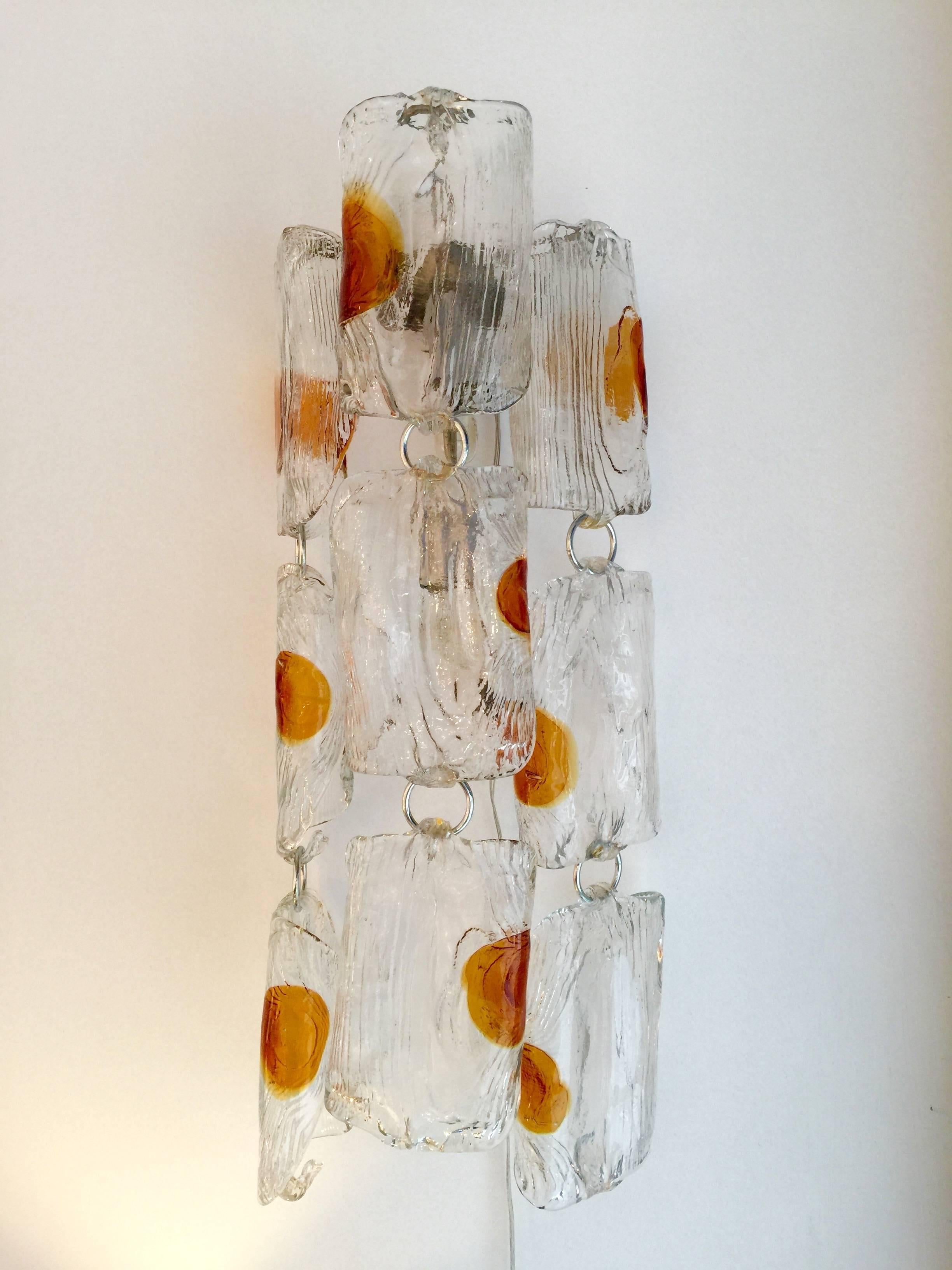 Rare pair of Mid-Century Modern hanging Murano glass sconces or wall lights by Toni Zuccheri for the manufacture Mazzega, 1970s. Those orange points in the glass are typical from Toni Zuccheri works. An italian design from the 70s. The glass