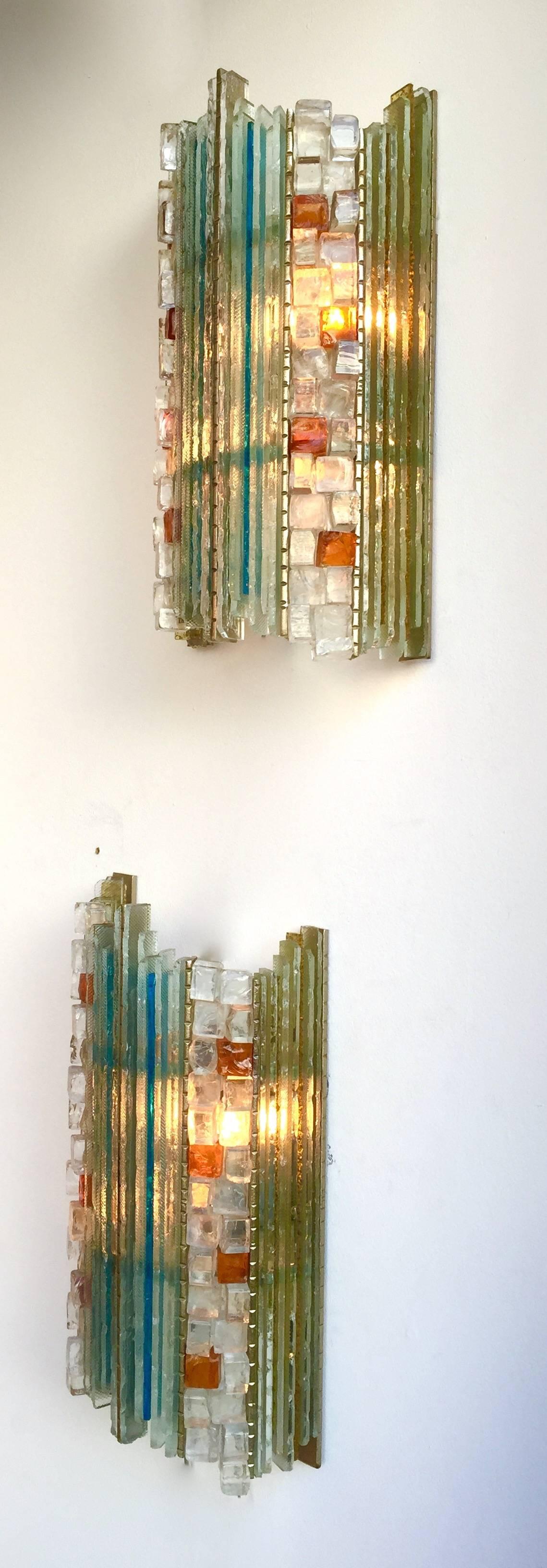 Very rare pair of Mid-Century Modern sconces by B&J Arte in Verona. The sconces are made in cut-glass mounted on a brass structure. B&J Arte is an Artistic handmade few production numbering from as few as a single example. It was the direct