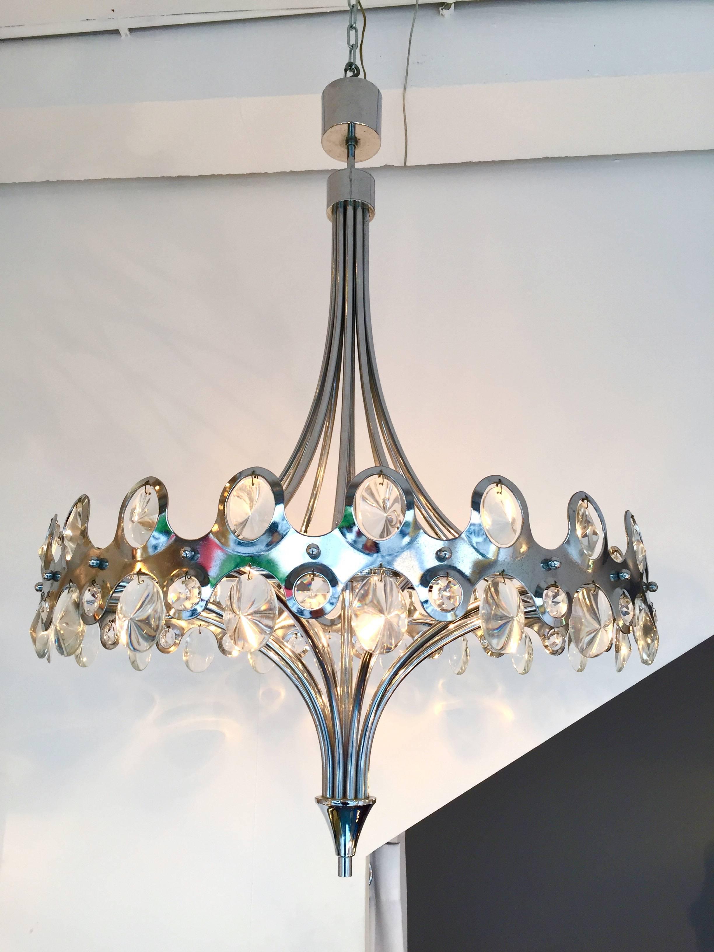 Mid-Century Modern crystal chandelier or ceiling pendant light by the designer Gaetano Sciolari. A touch of slight neoclassical style from Sciolari. Metal chrome and crystal glass. Perfect condition. Sciolari is a famous maker of the 1970s-1980s