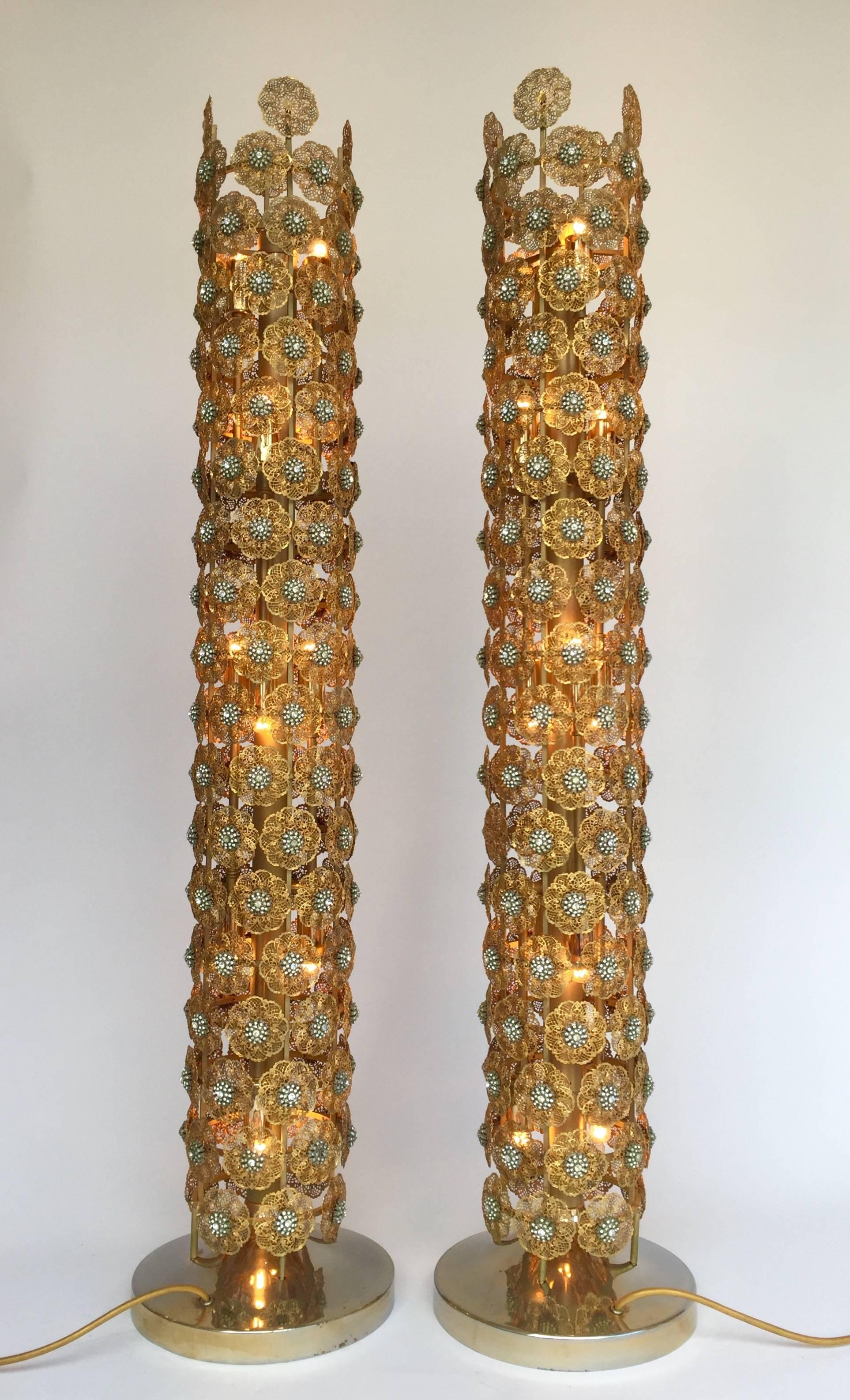 Very rare and unusual pair of column floor lamps by the crystal lightning editor Faustig Munich, Germany. A precious manufacturing of brass filigree with crystal. All elements are screwing mounted on brass structure. We can talk about floor lamps in
