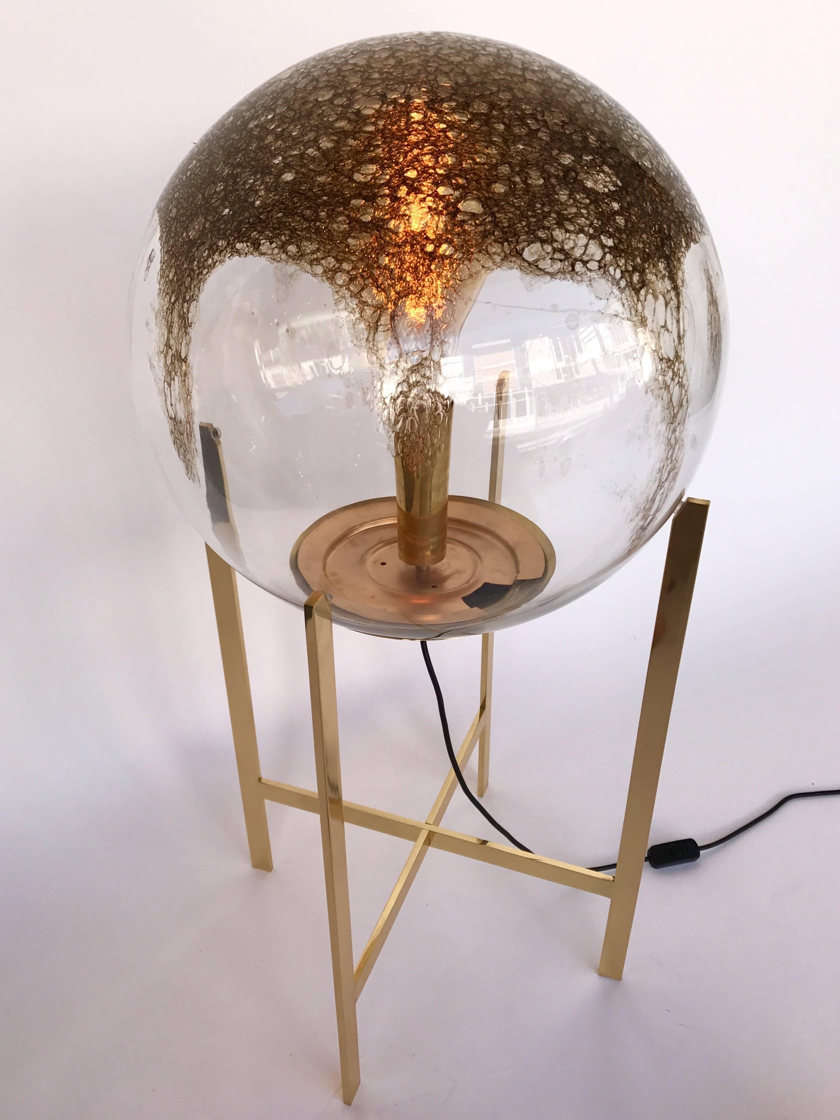 Impressive and decorative pair of floor lamps or huge table lamps by the editor La Murrina at Murano. Blown glass sphere with oxide of iron, which gives it this bronze color. Simple and elegant polish brass structure. Normal E26 bulbs can be use.