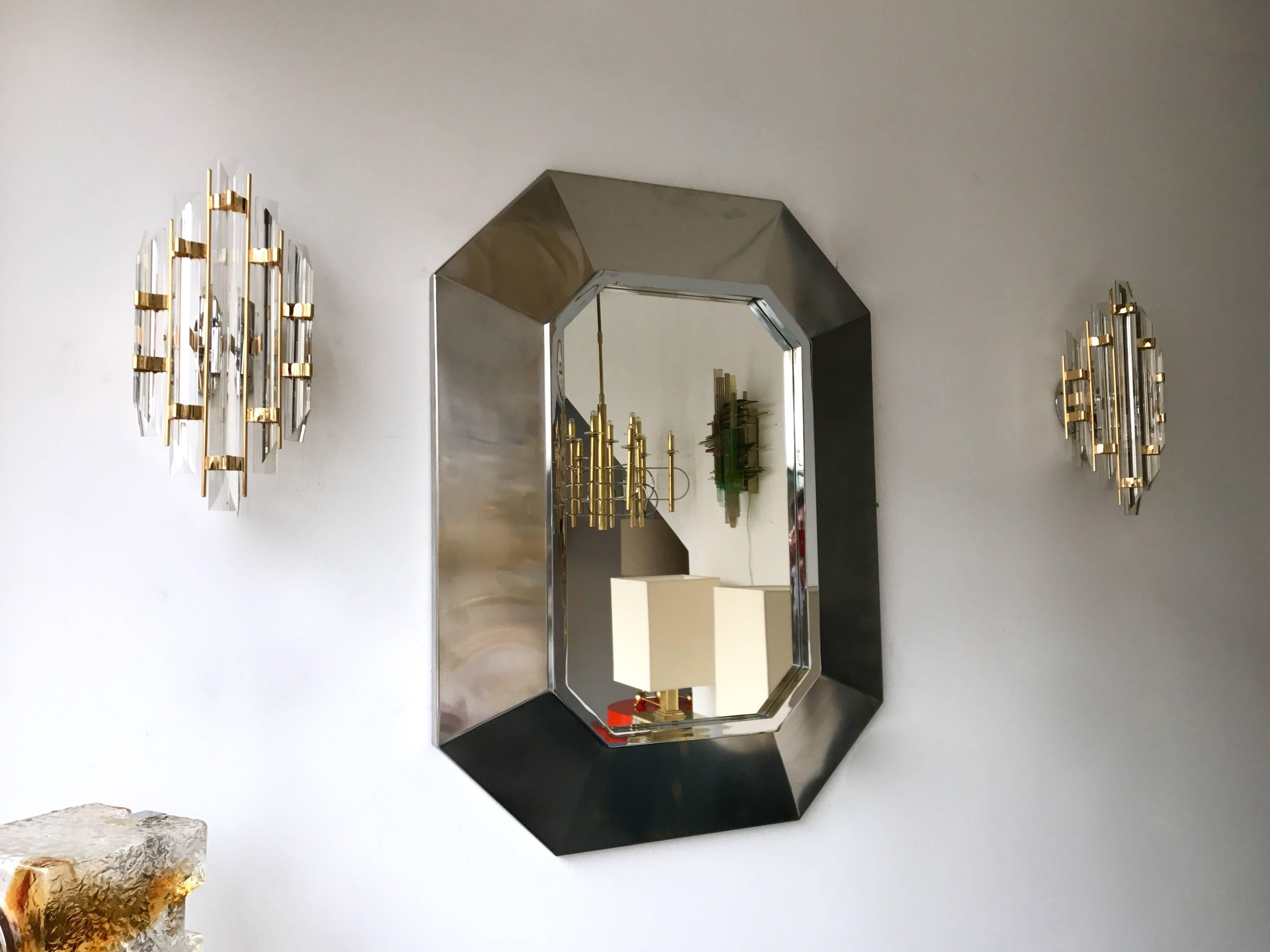 Brushed and polished natural stainless steel wall mirror by Maison Jansen, famous model of the manufacture. Design like Bagues, Romeo Rega, Guy Lefevre, Jean Claude Mahey, Hollywood Regency, Willy Rizzo